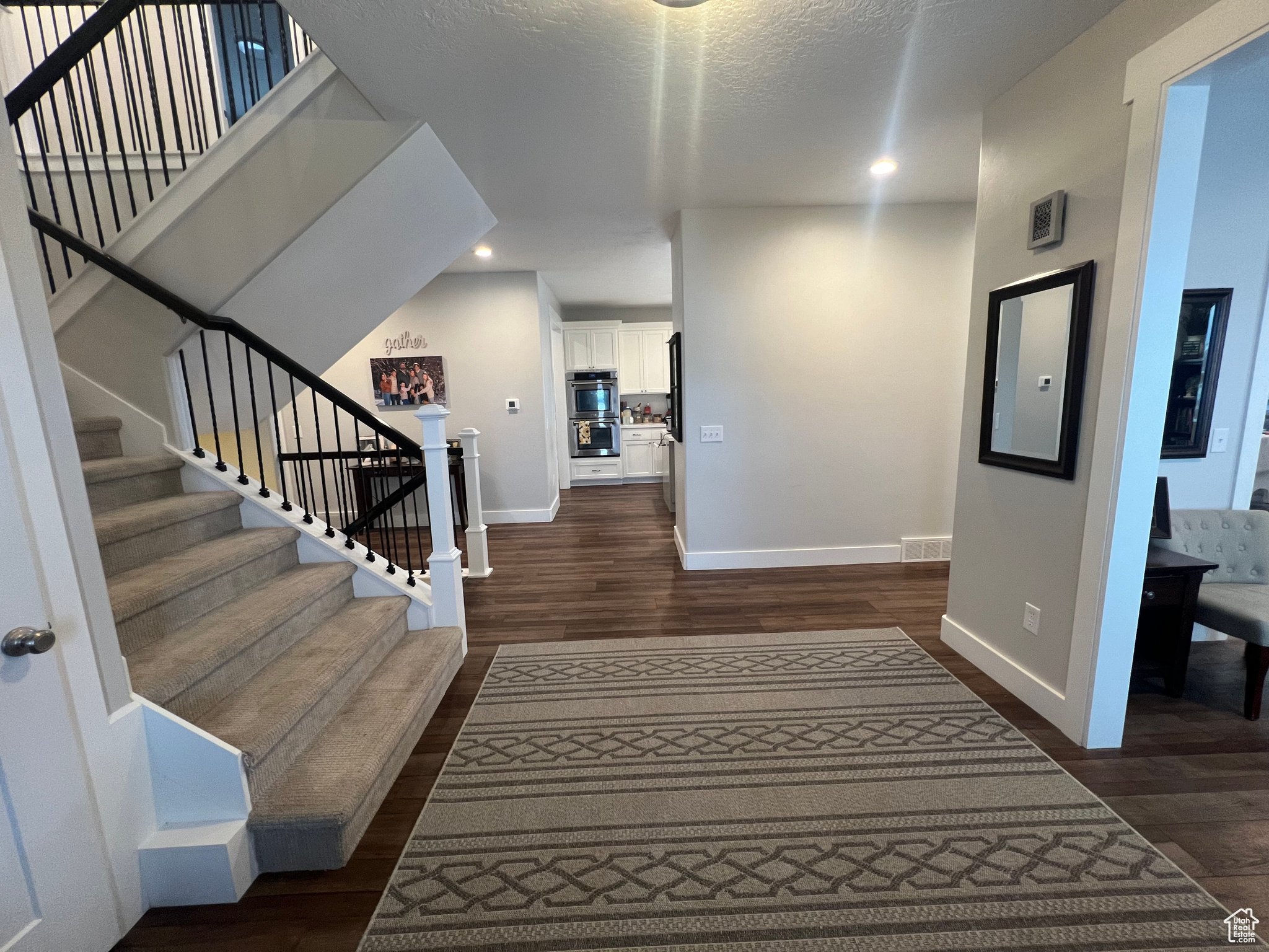 Entryway featuring dark hardwood / wood-style flooring and a textured ceiling
