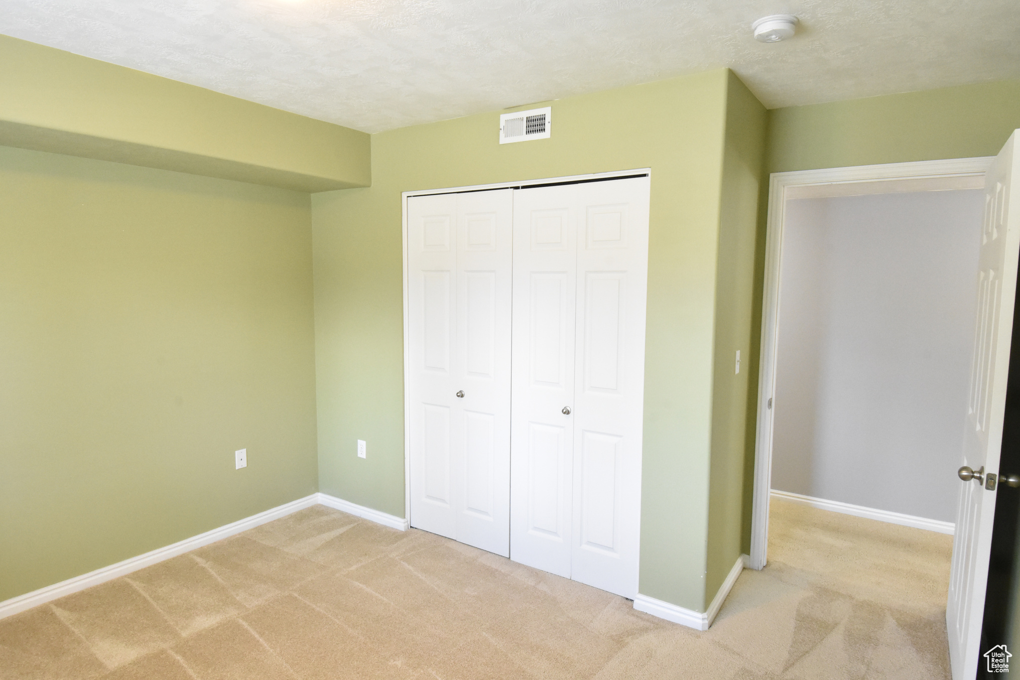 Unfurnished bedroom with a closet and carpet flooring