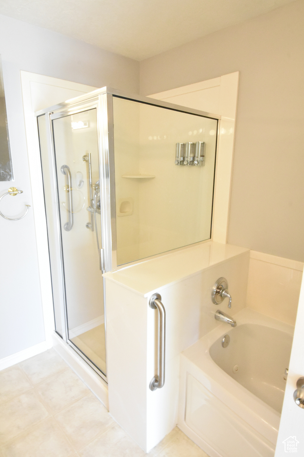 Bathroom featuring tile floors and plus walk in shower