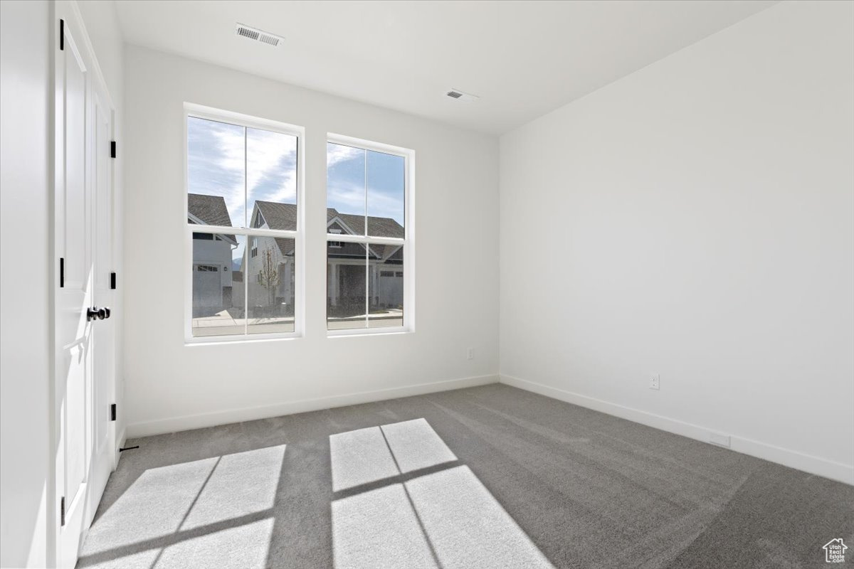 Unfurnished room with carpet