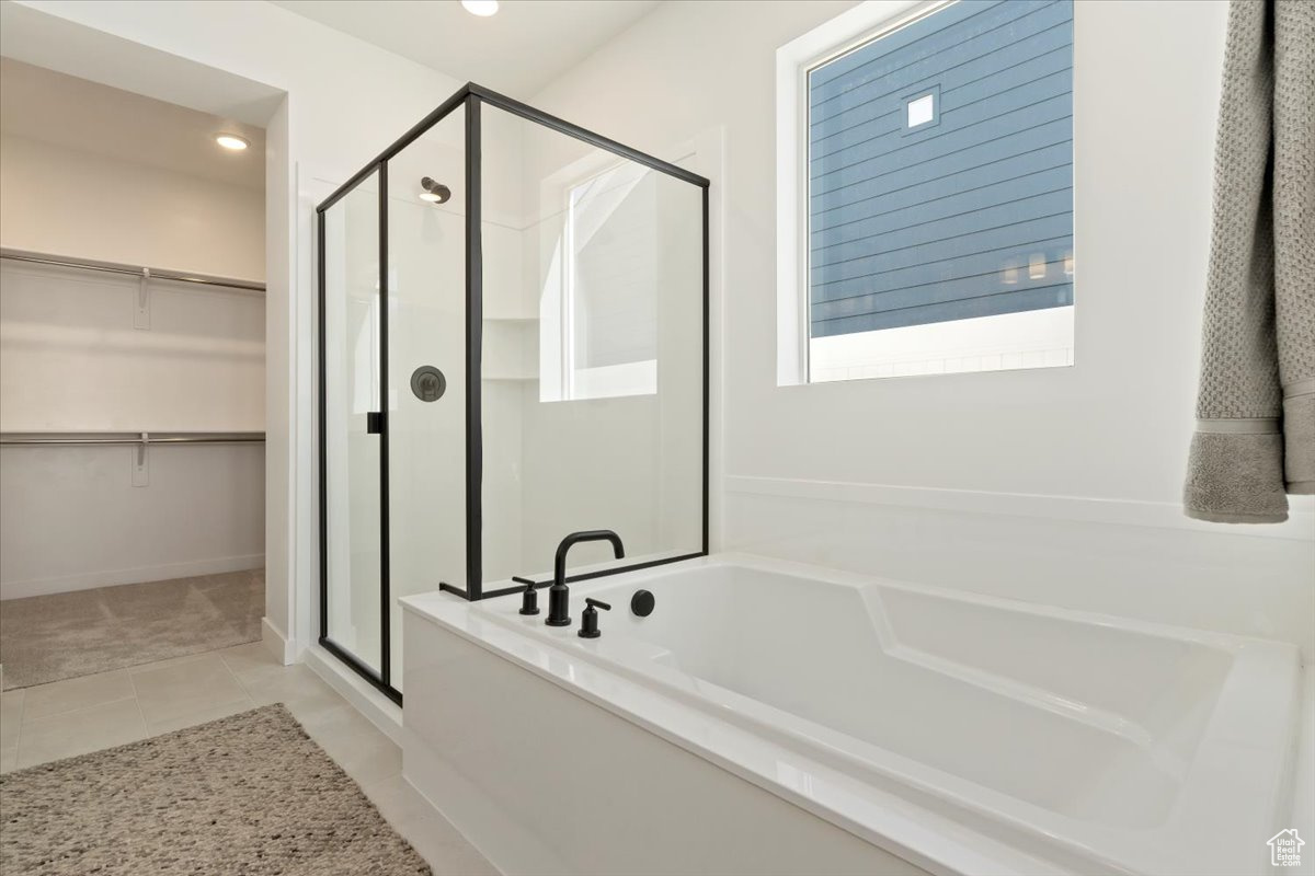 Bathroom featuring tile flooring and separate shower and tub