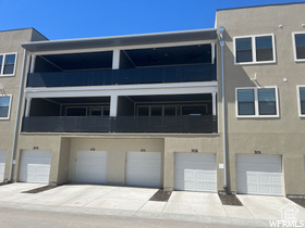Exterior space featuring a garage and a balcony