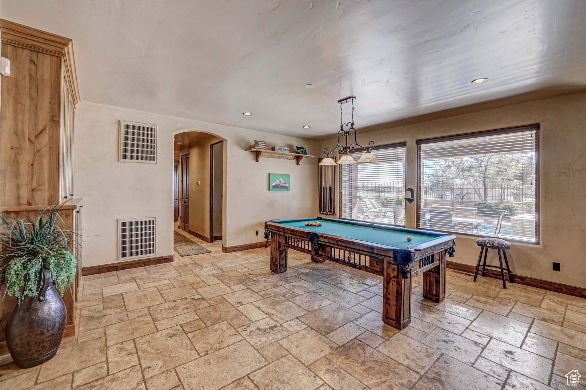 Rec room featuring a healthy amount of sunlight, light tile floors, and billiards