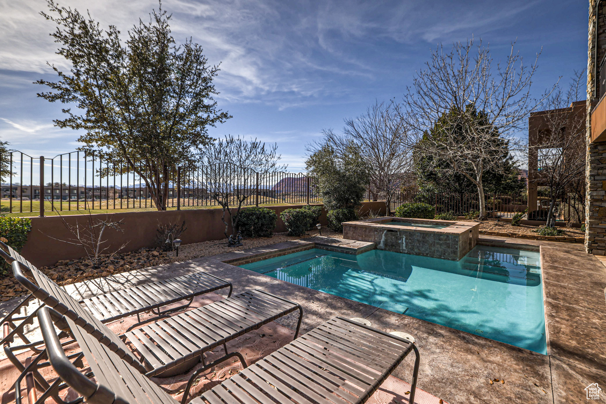 View of swimming pool with an in ground hot tub and a patio