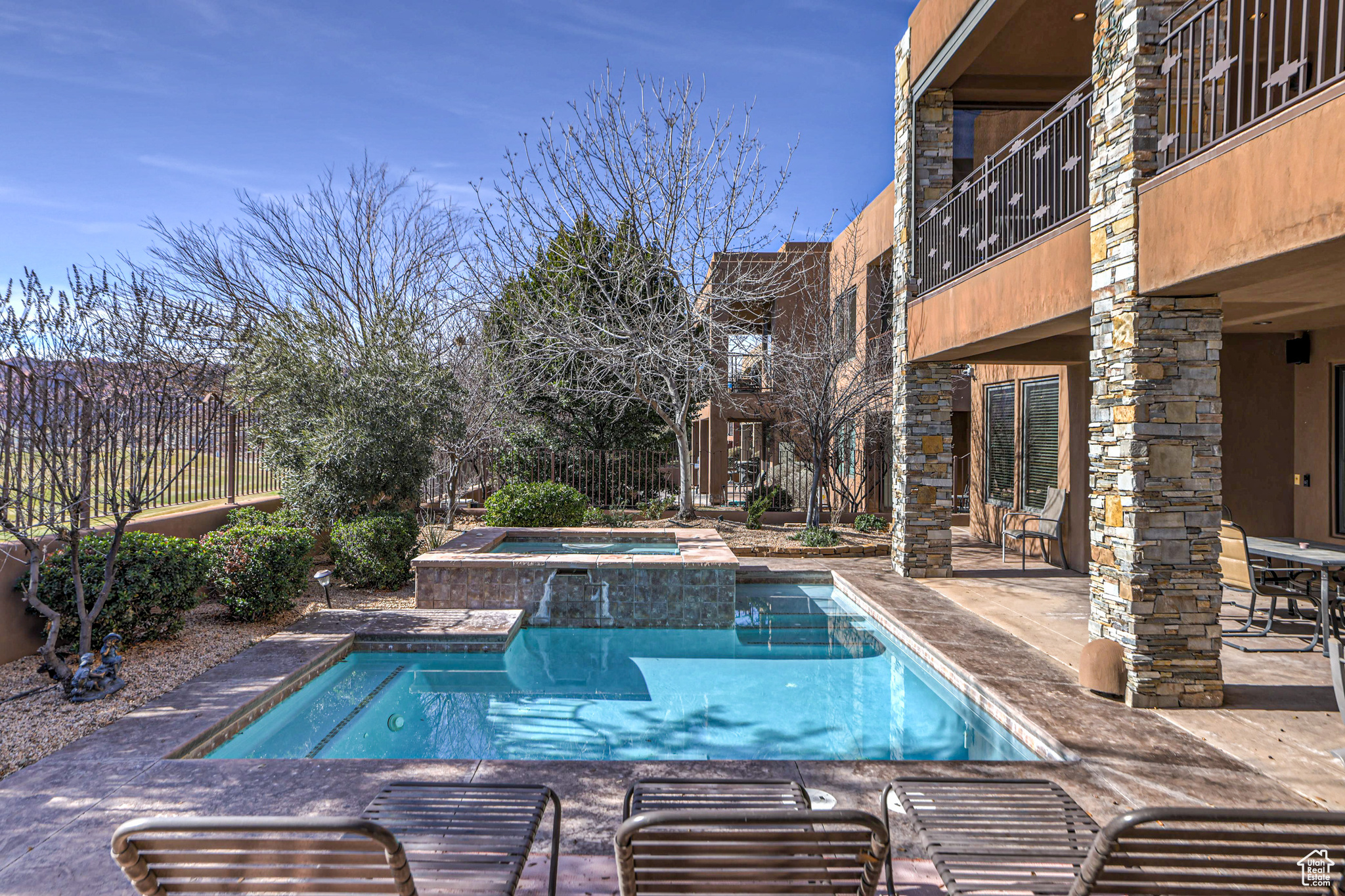 View of swimming pool with a patio and an in ground hot tub