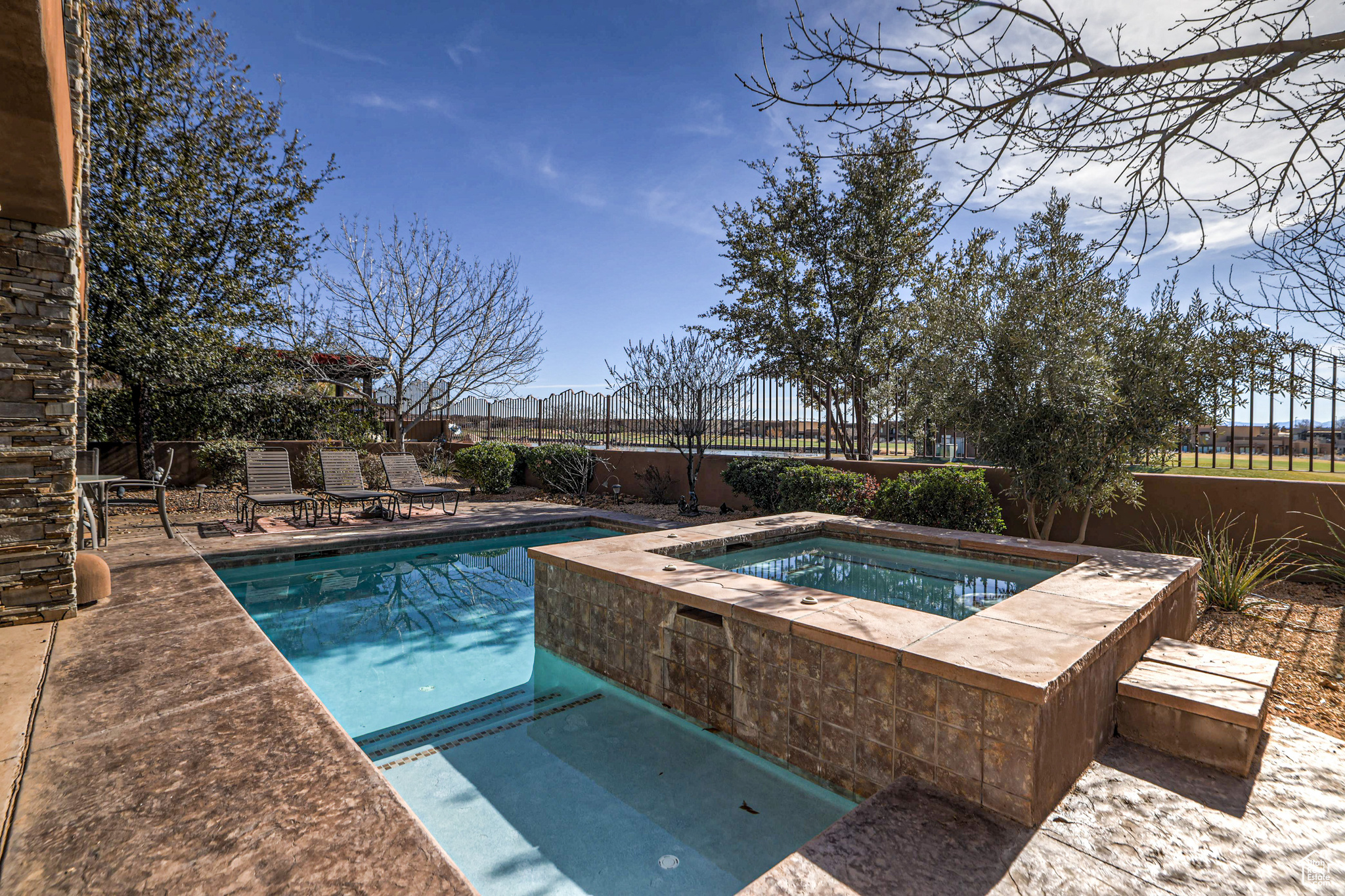 View of swimming pool featuring an in ground hot tub and a patio