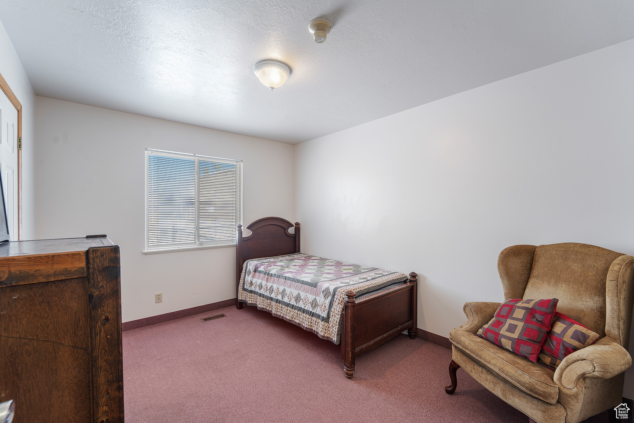 Bedroom with dark carpet