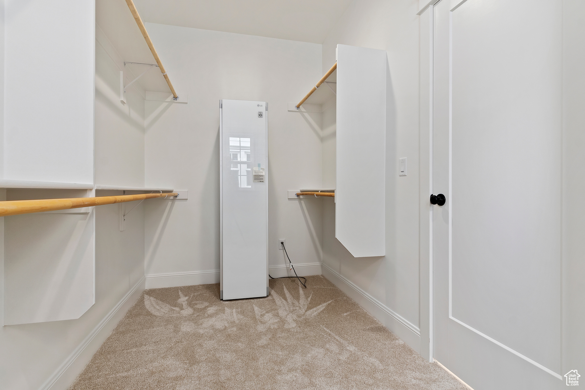 Master bedroom walk in closet featuring clothing steamer