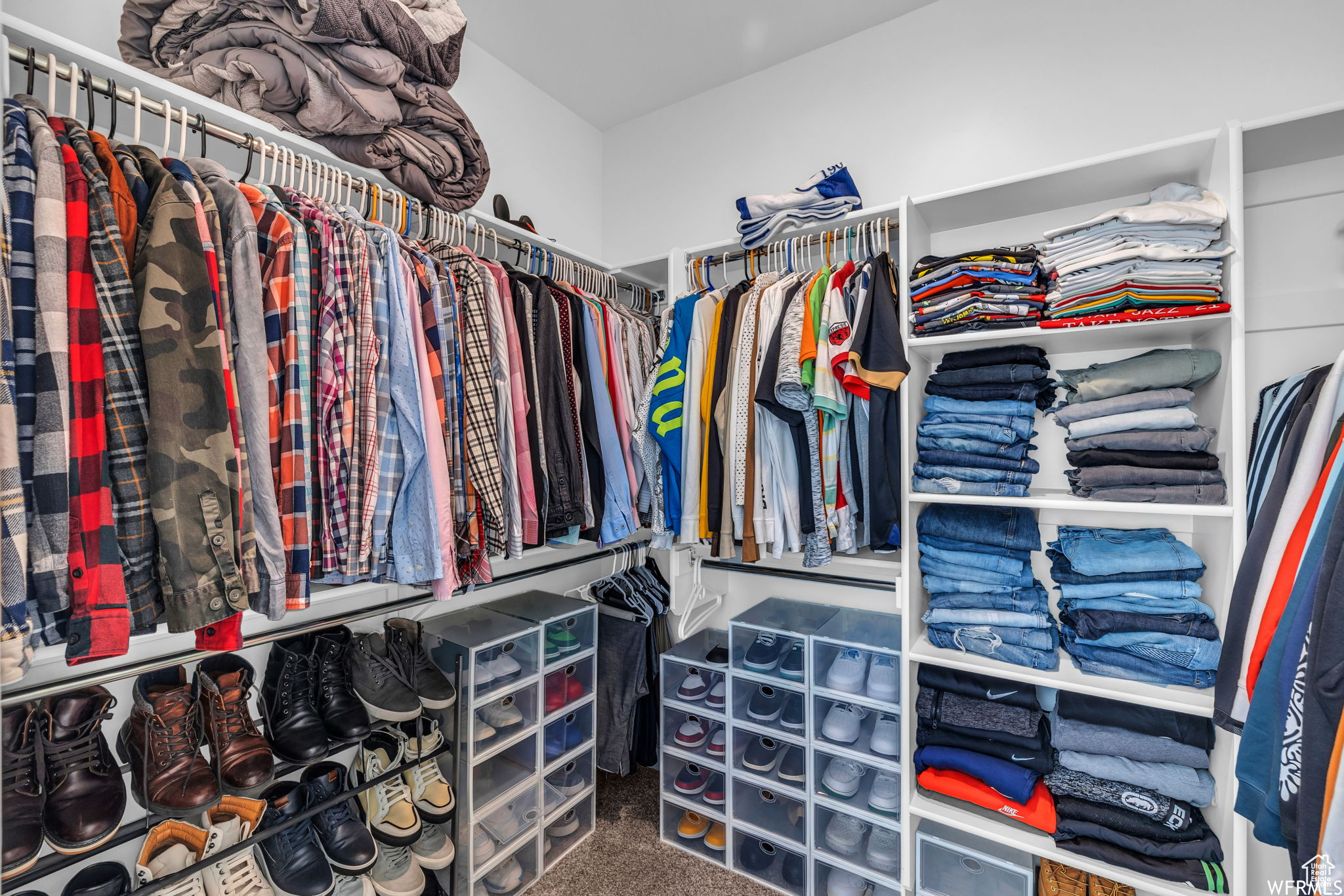 Spacious closet with dark carpet