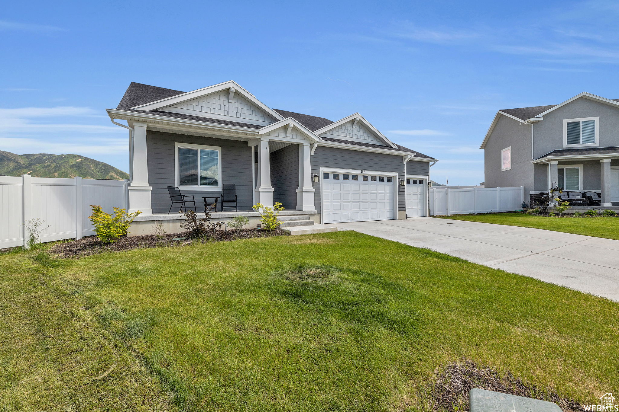 View of front of property with a front yard and a garage