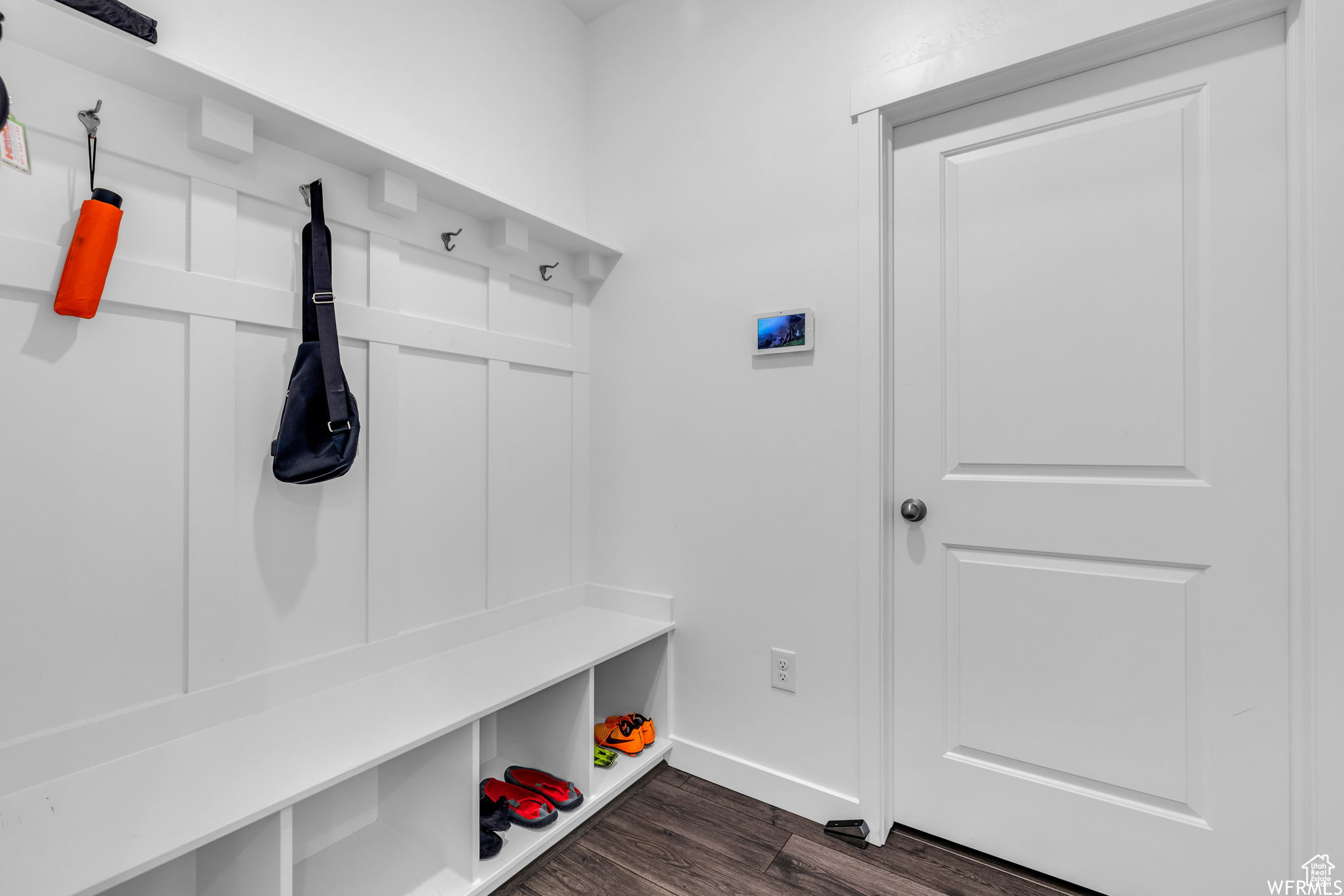 Mudroom with dark hardwood / wood-style flooring