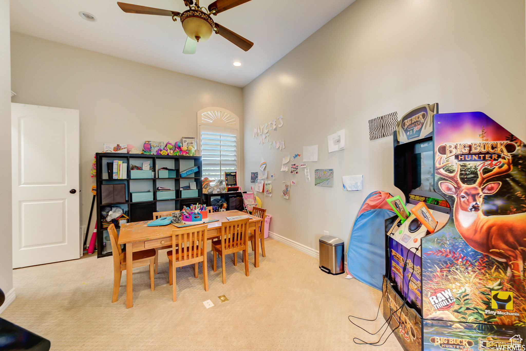 Playroom with ceiling fan and light carpet