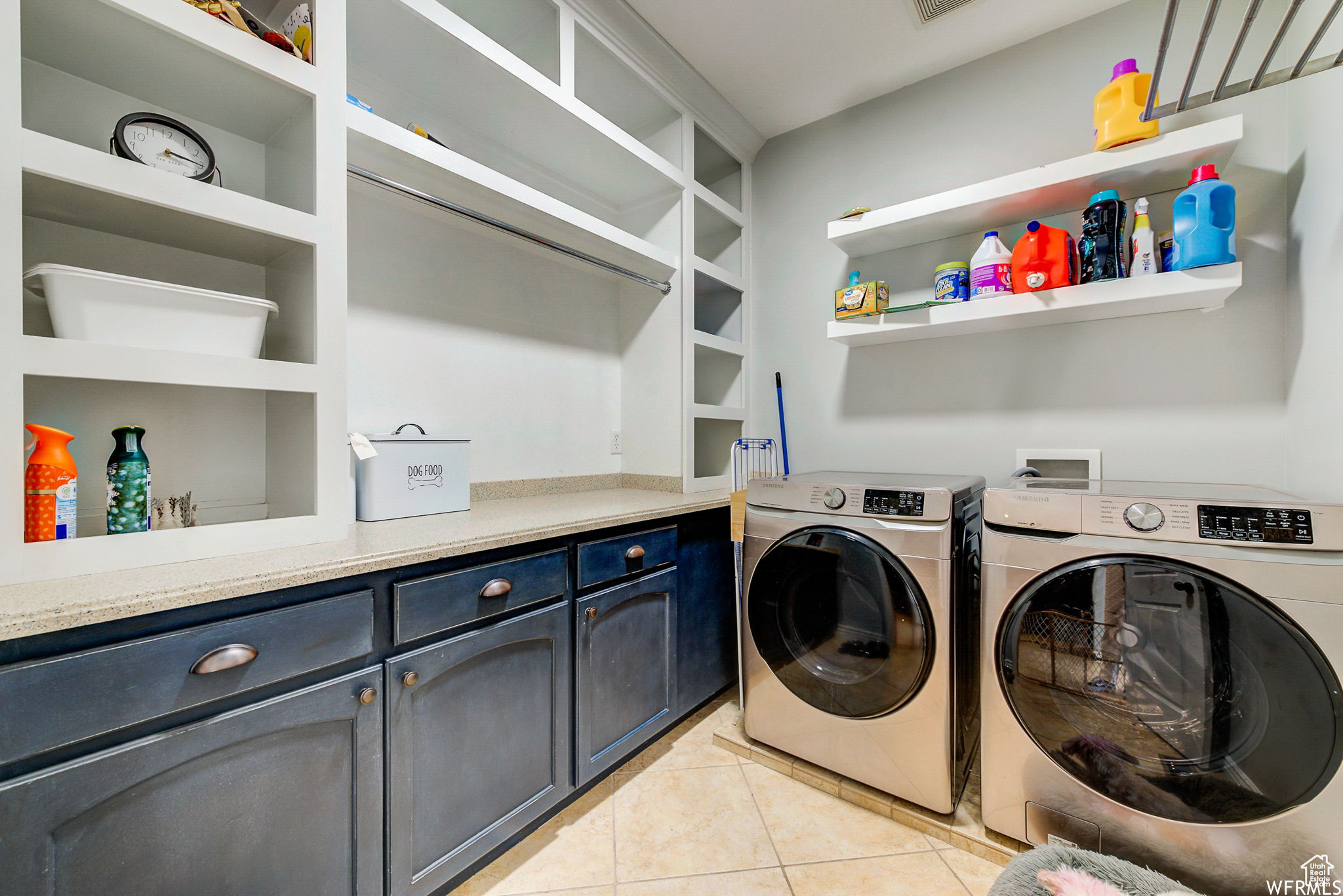 Washroom featuring light tile floors, cabinets, hookup for a washing machine, and independent washer and dryer