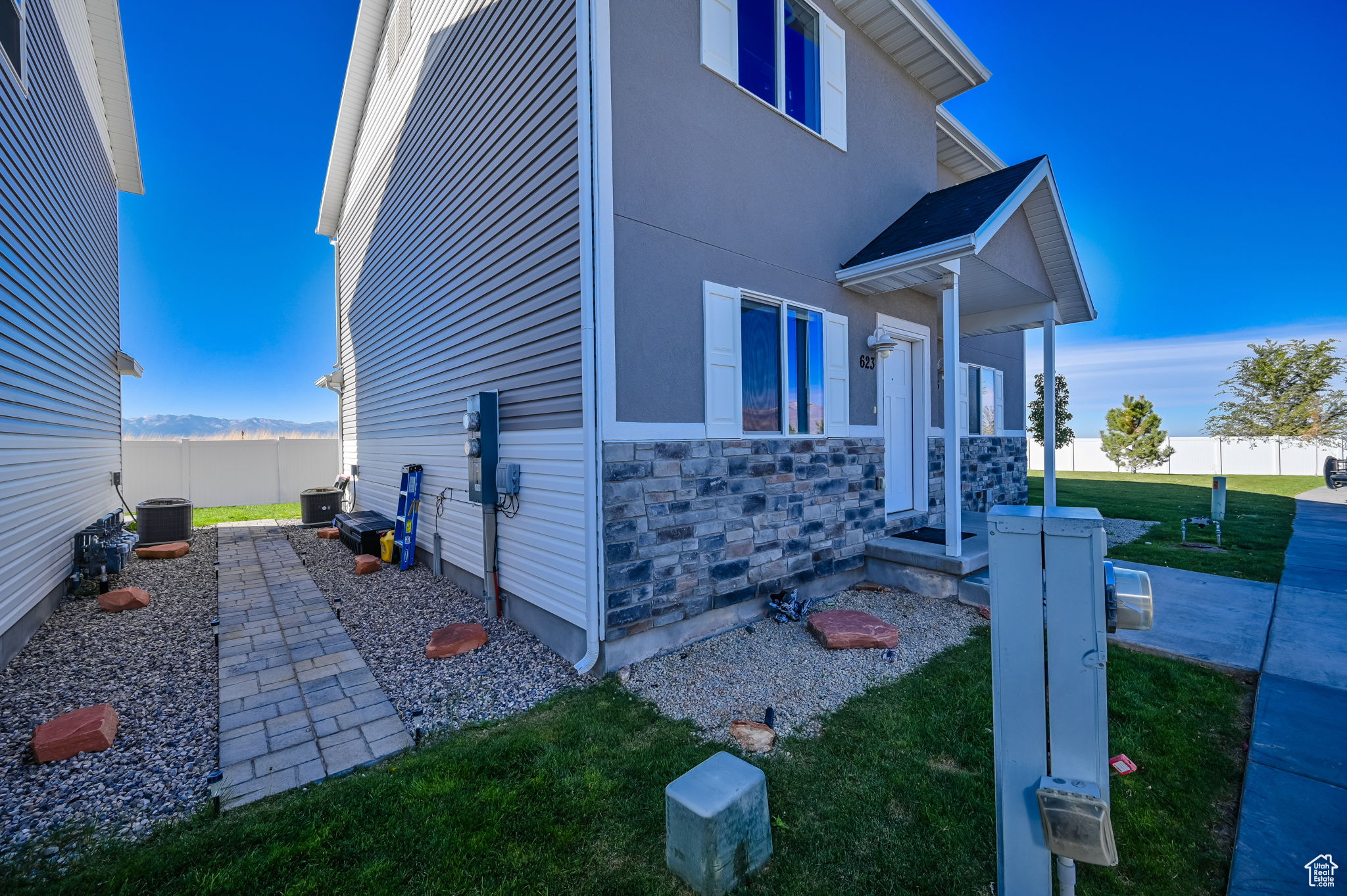 View of home's exterior featuring central AC and a lawn