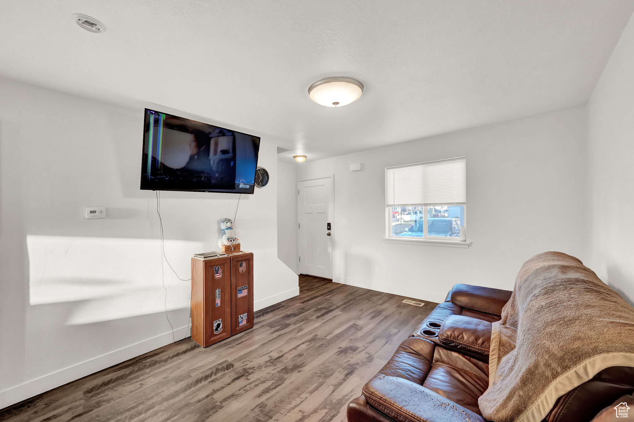 Living room with dark hardwood / wood-style flooring