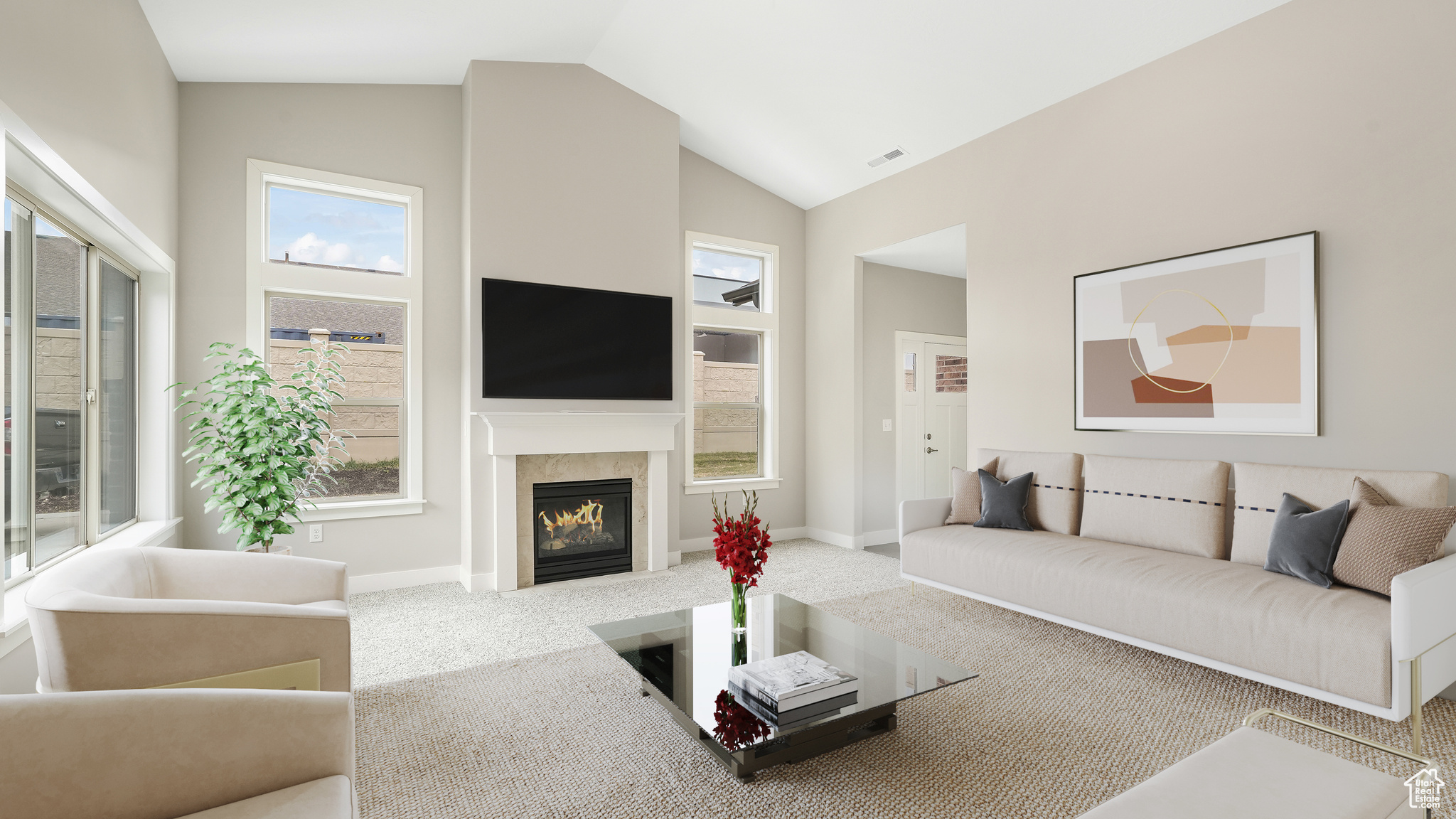 Great room with cozy fireplace and vaulted ceilings.