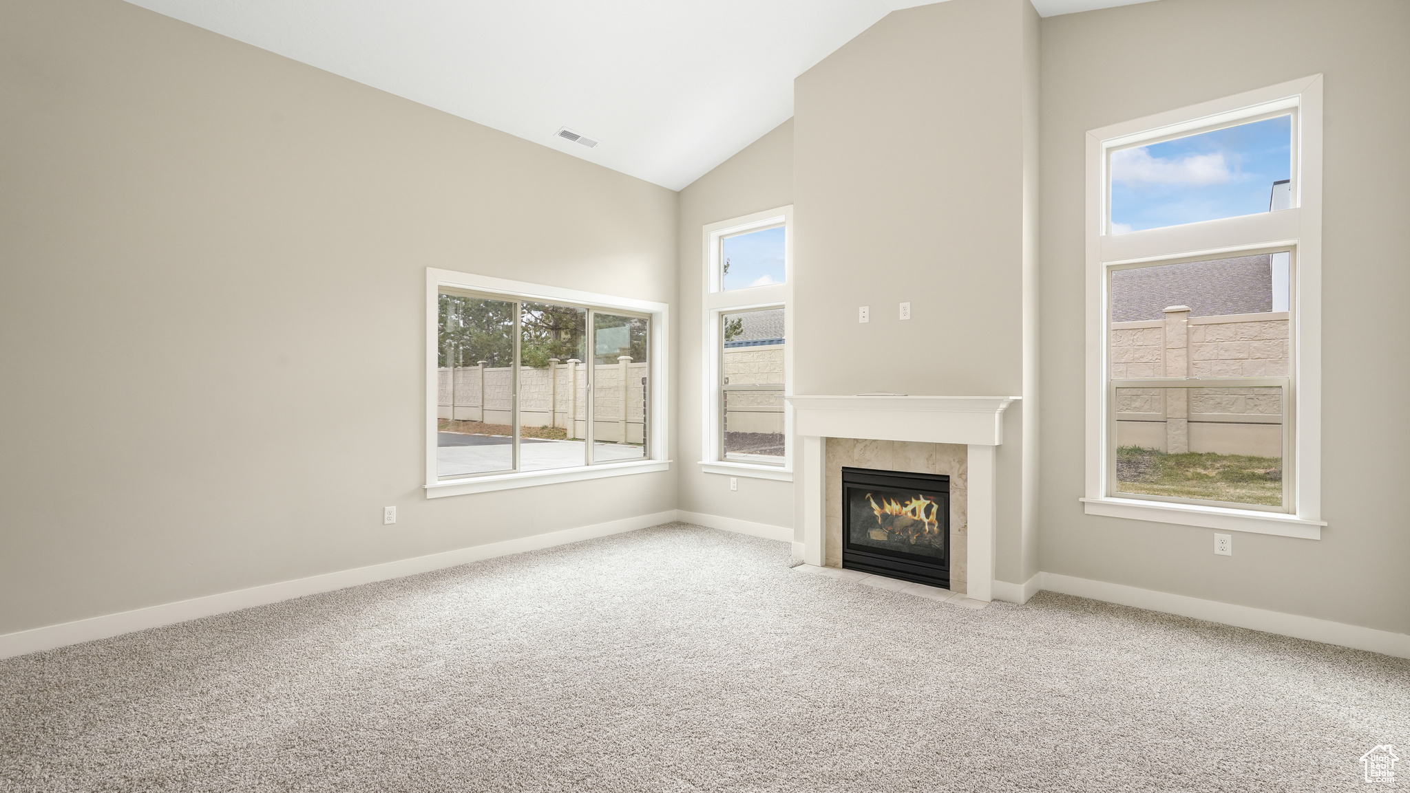 Great room with cozy fireplace and vaulted ceilings.