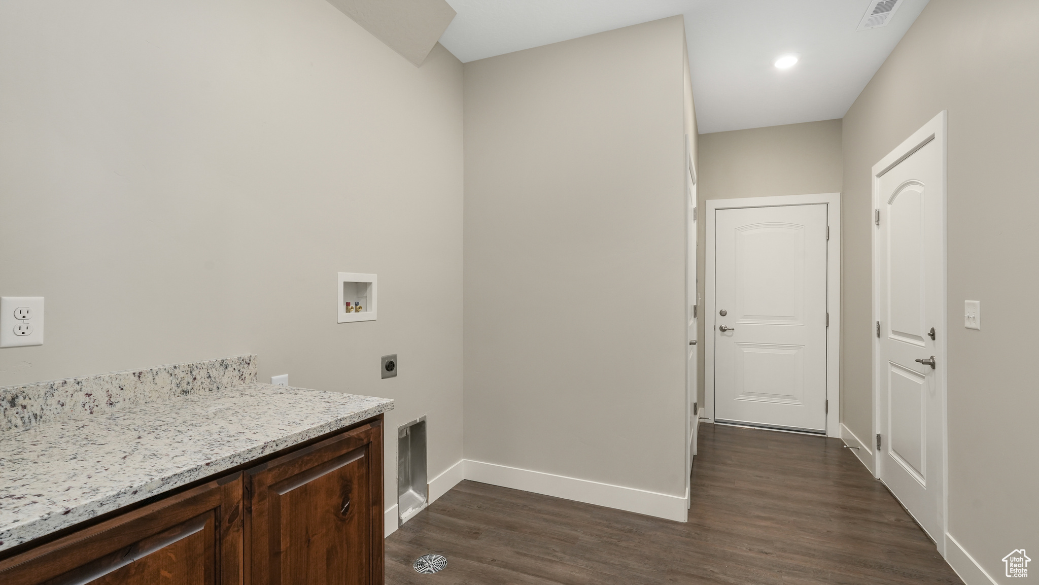 Laundry room with extra storage and access to garage and breezeway.