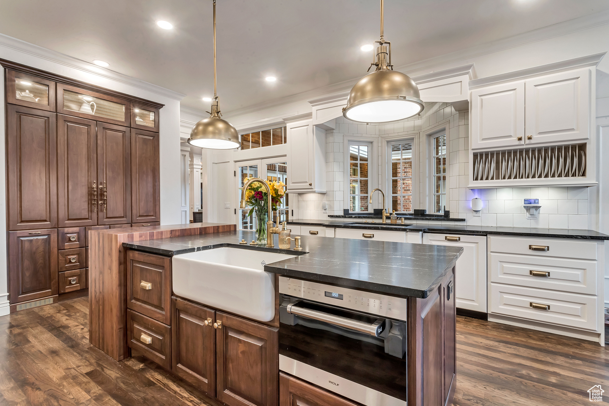 Kitchen featuring a kitchen island, dark wood flooring, oven, and hanging light fixtures