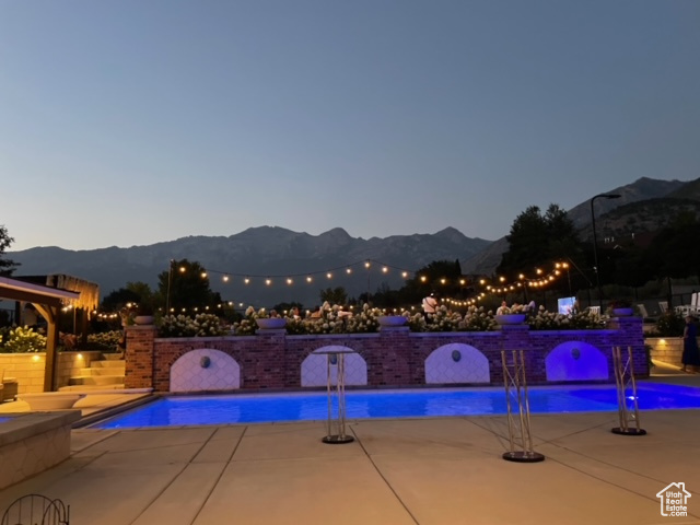 View of pool featuring a mountain view and a patio