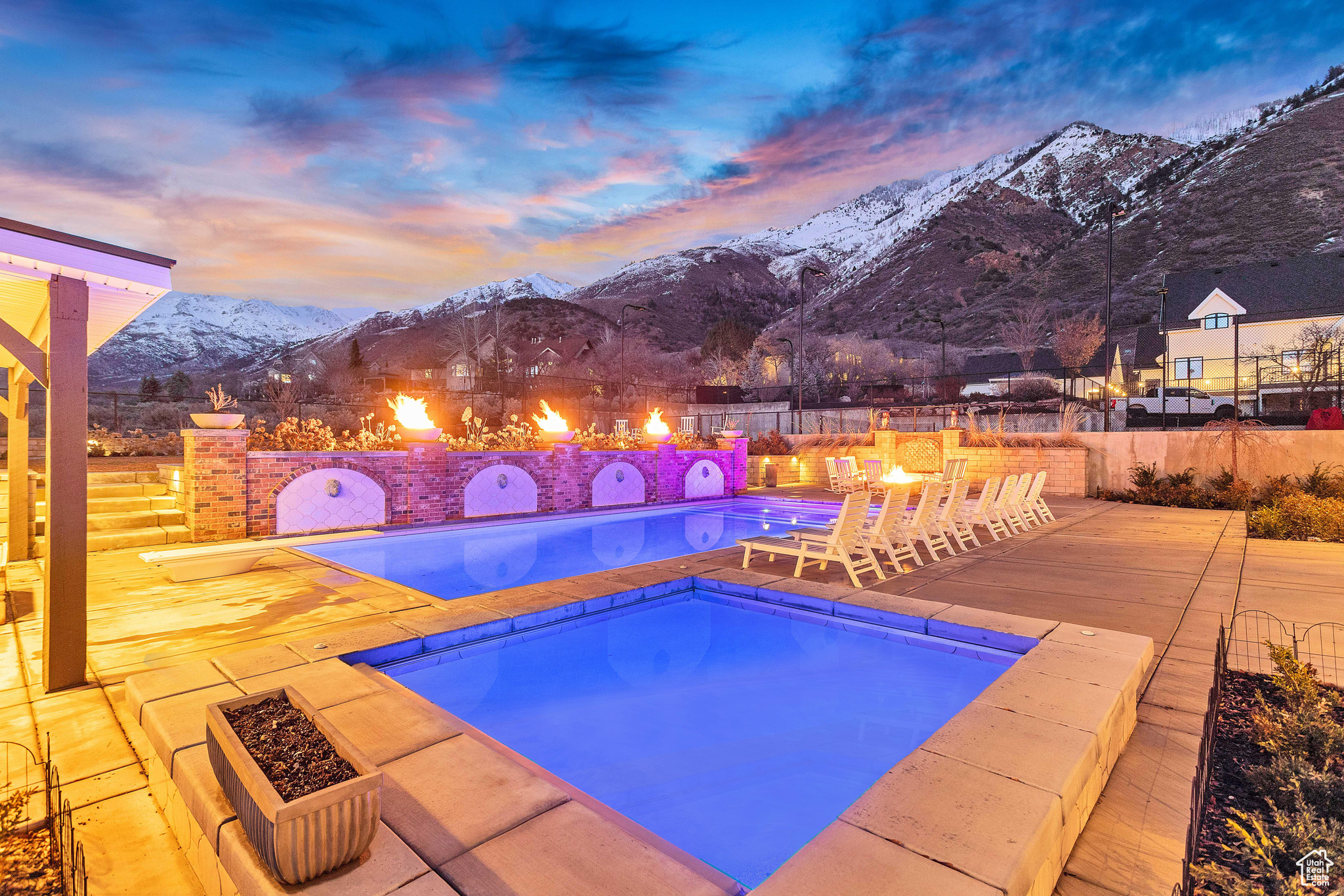 Pool at dusk with a patio area and a mountain view