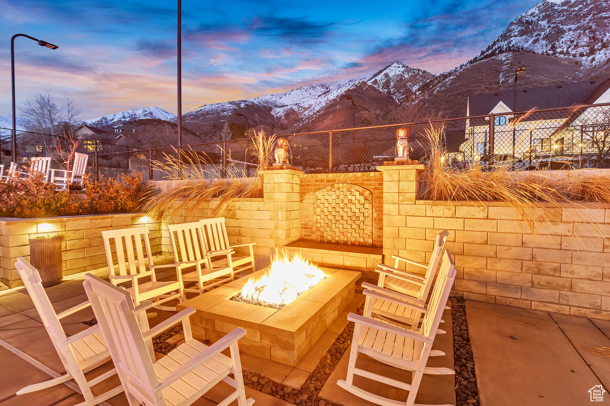 Patio terrace at dusk with a mountain view and an outdoor fire pit
