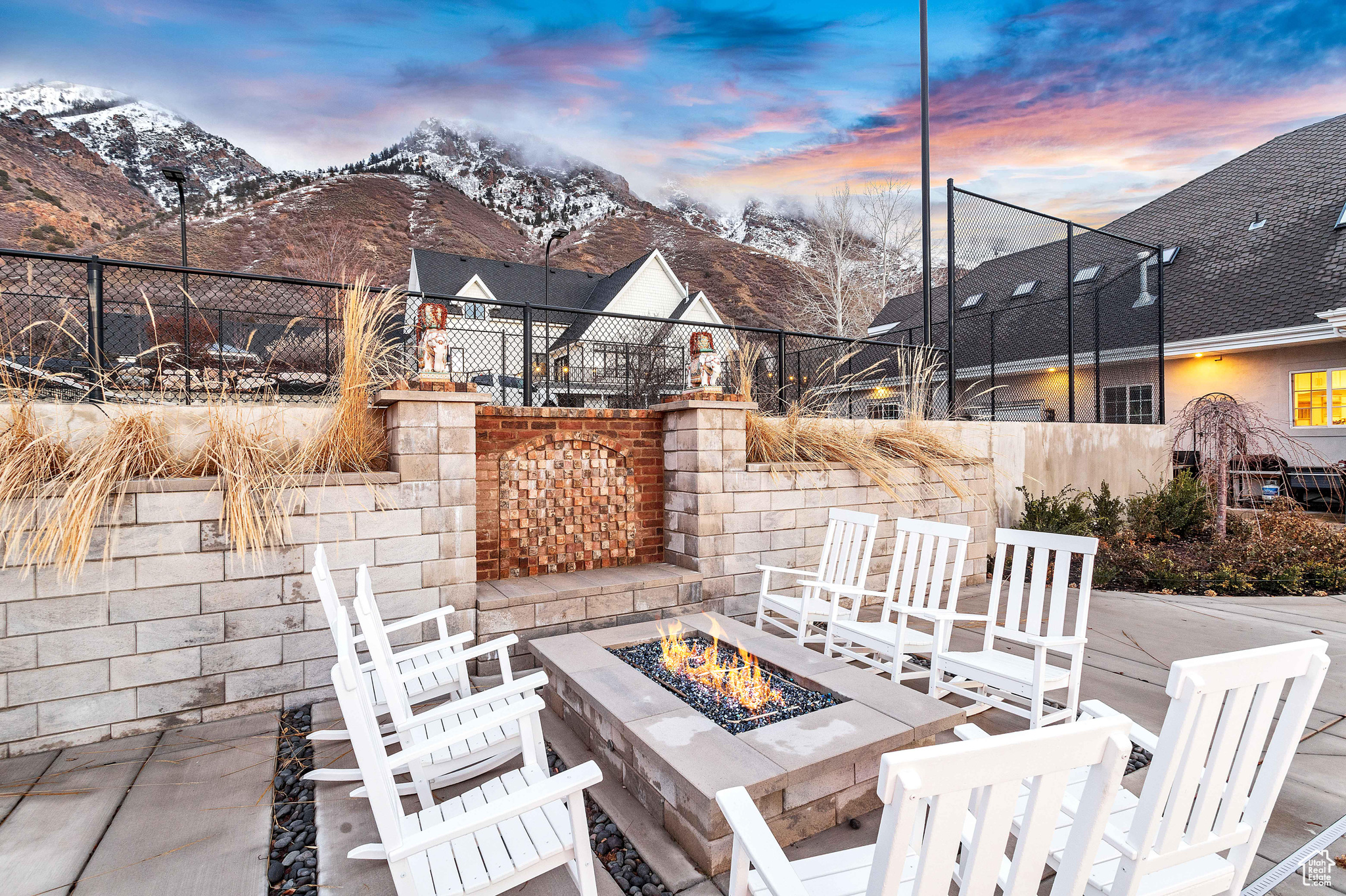 Patio terrace at dusk featuring a mountain view and a fire pit