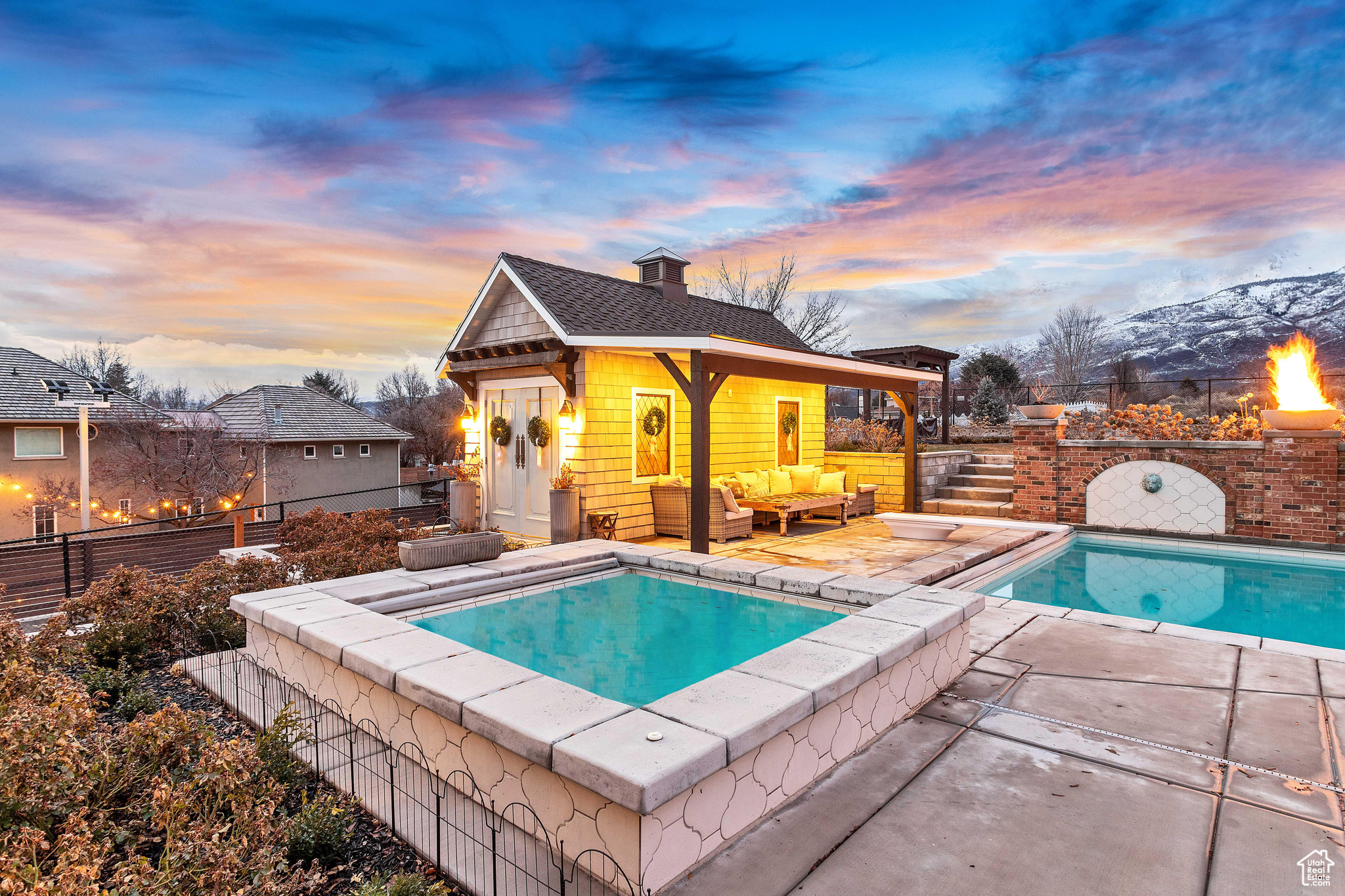 Pool at dusk with an outdoor living space and a patio area