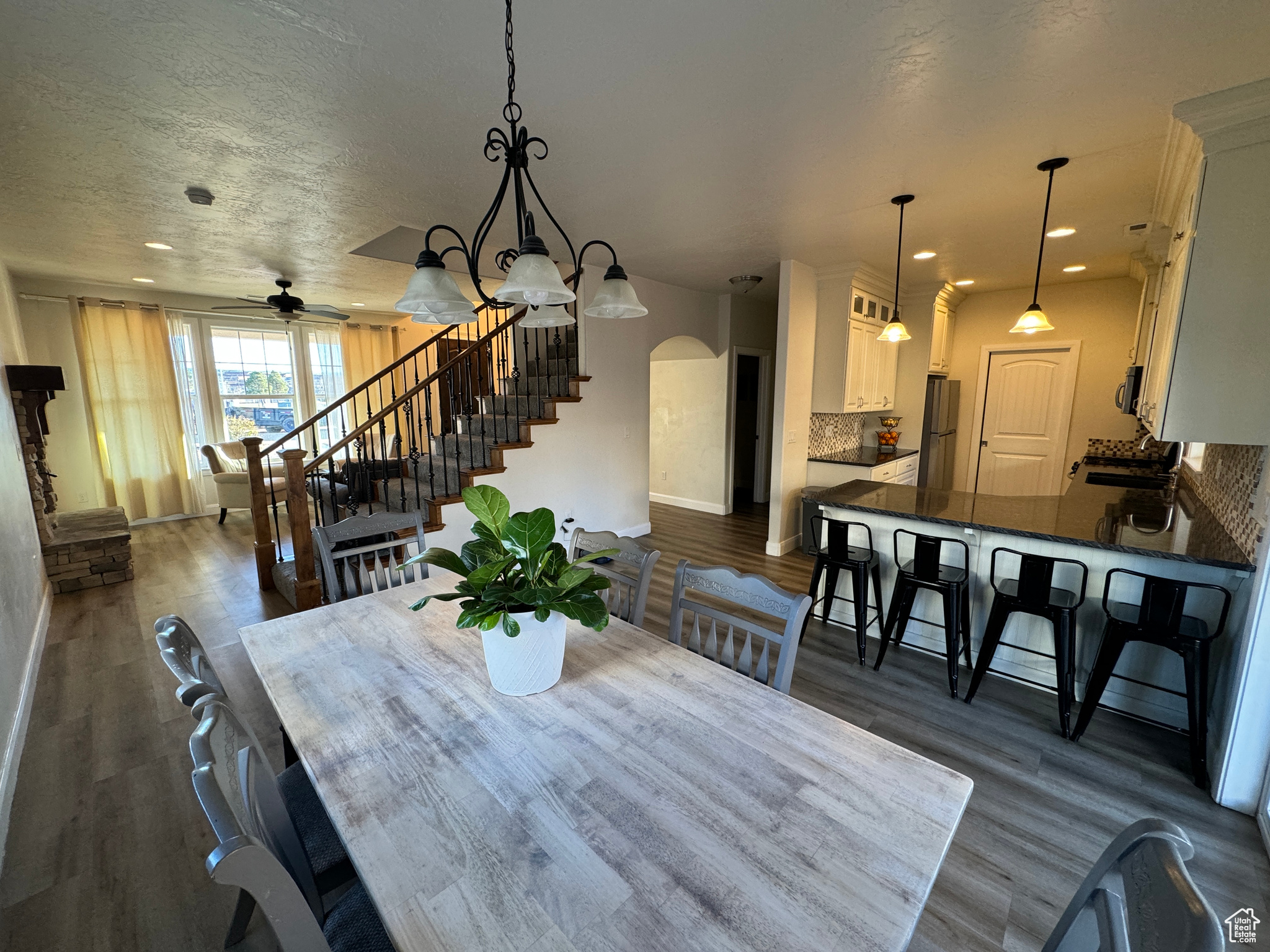 Dining space with dark hardwood / wood-style floors, ceiling fan, a textured ceiling, and sink