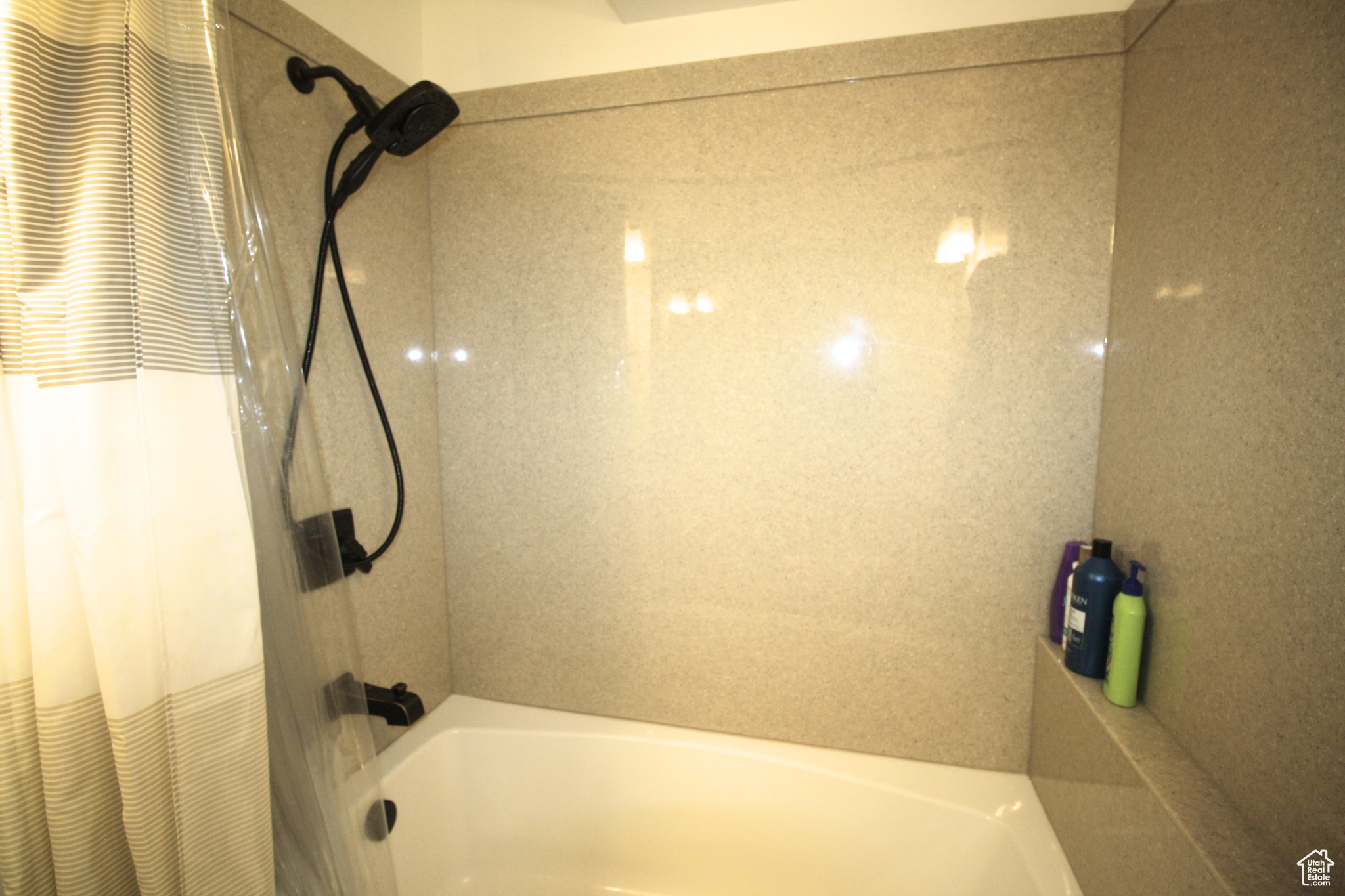 Bathroom featuring Marble shower / bath combo