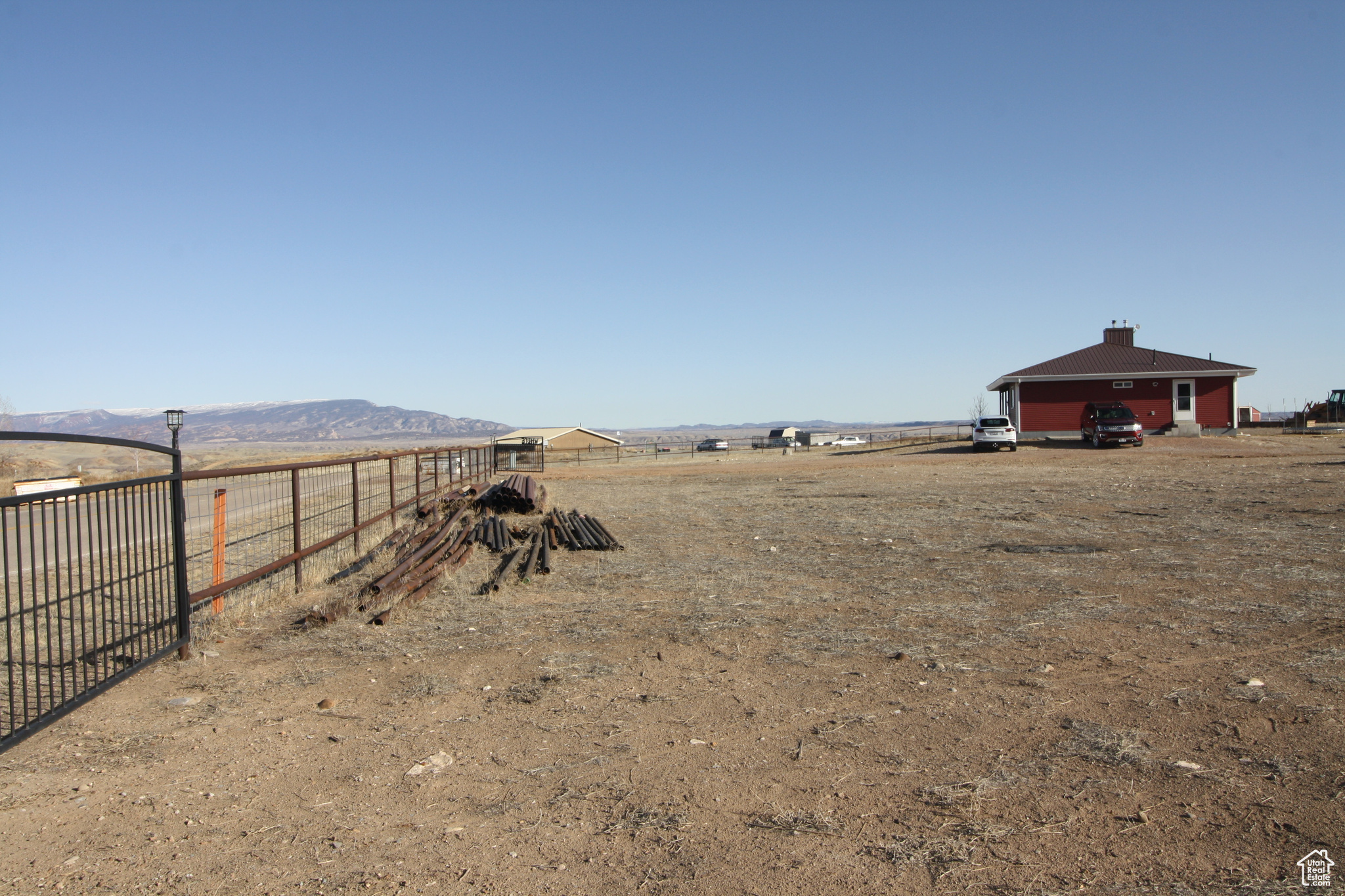 View of yard featuring a mountain view, a rural view, and pipe fence