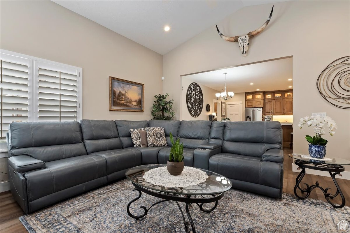 Living room featuring an inviting chandelier, high vaulted ceiling