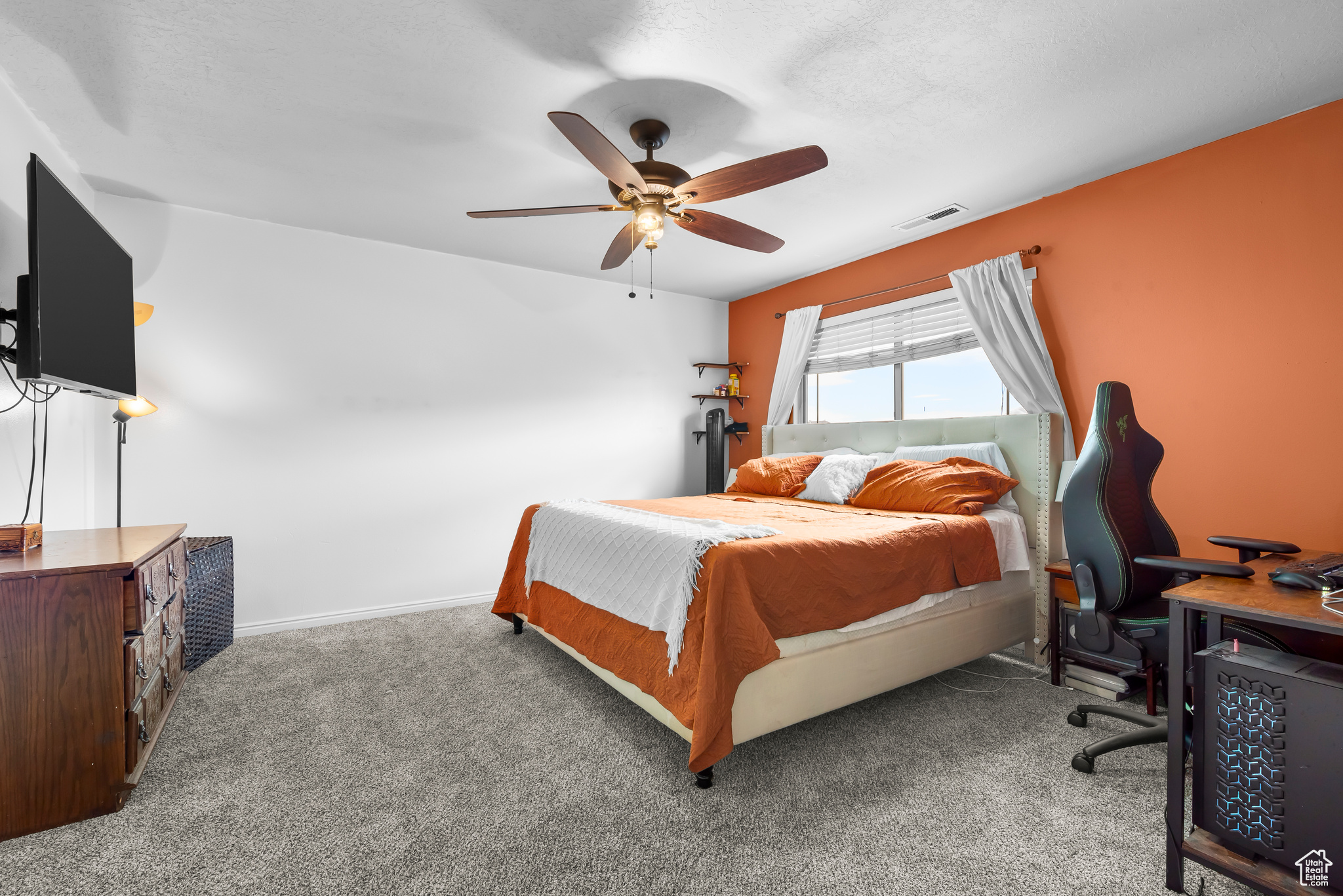 Master Carpeted bedroom with ceiling fan