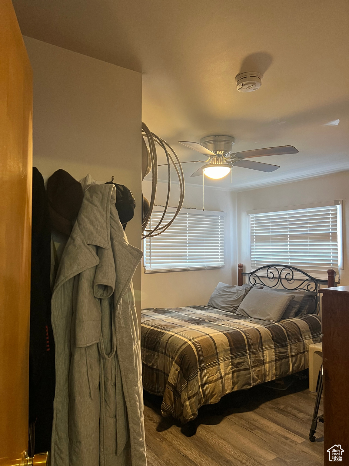 Bedroom featuring dark wood-type flooring and ceiling fan