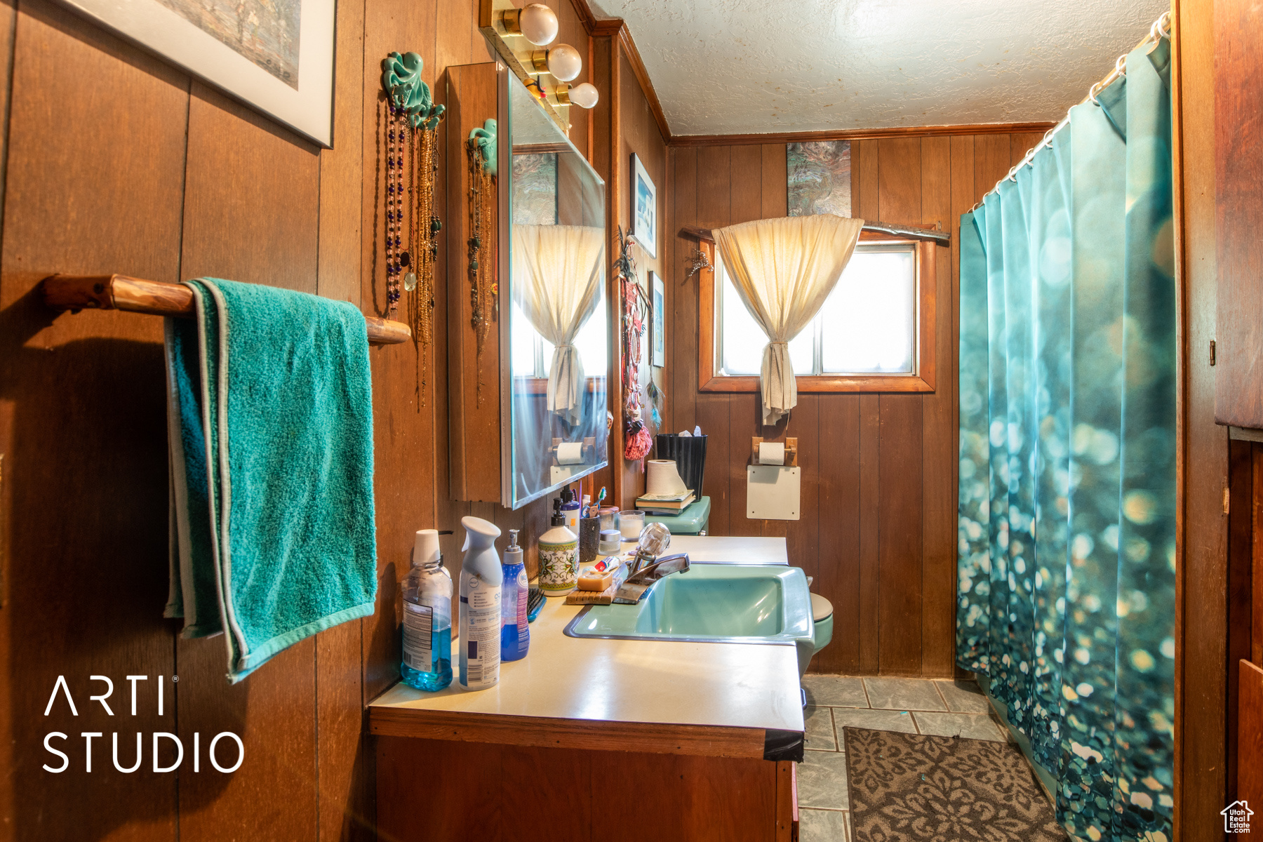 Bathroom featuring  vanity, toilet, wooden walls, and tile floors