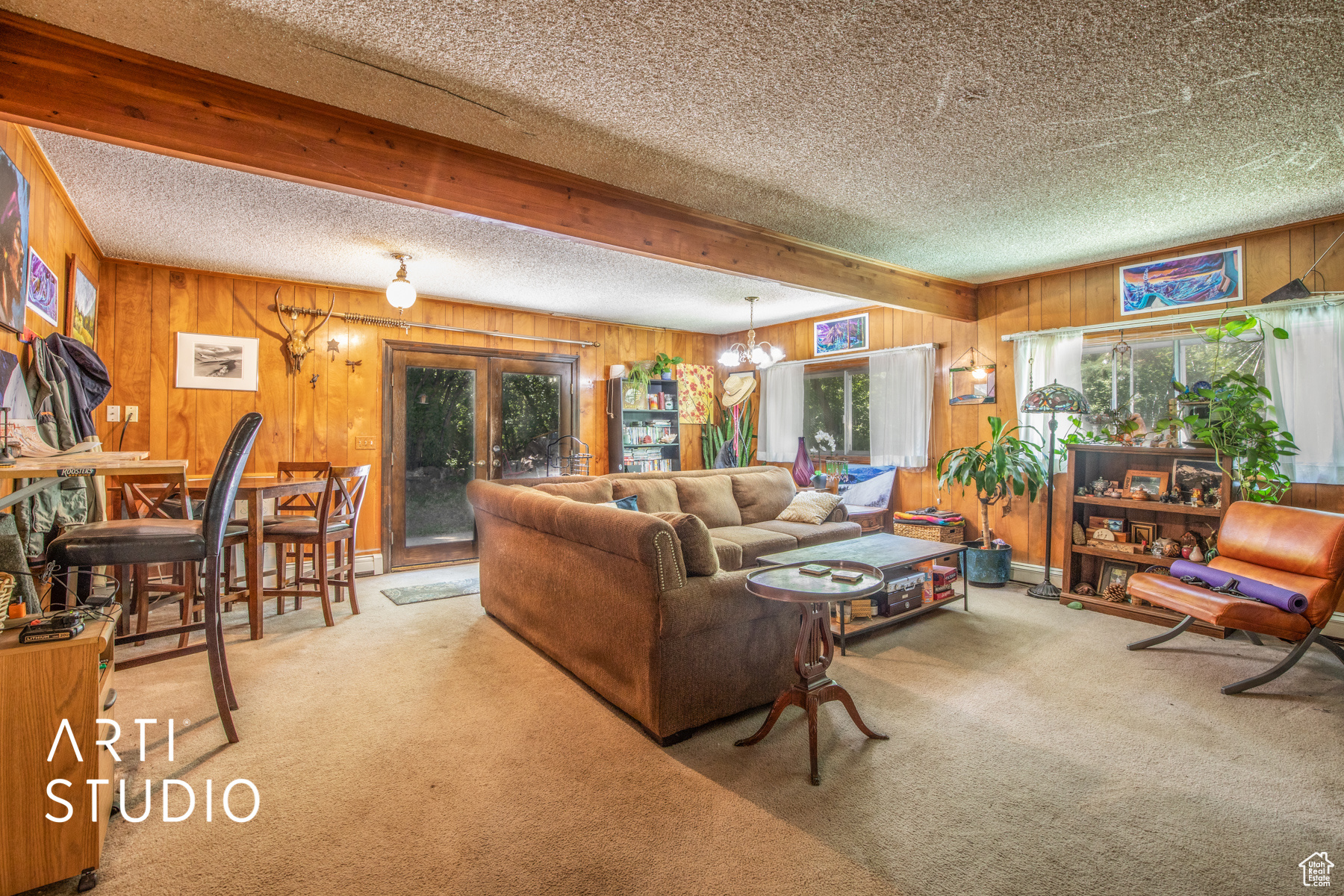 Carpeted living room with a space and french doors