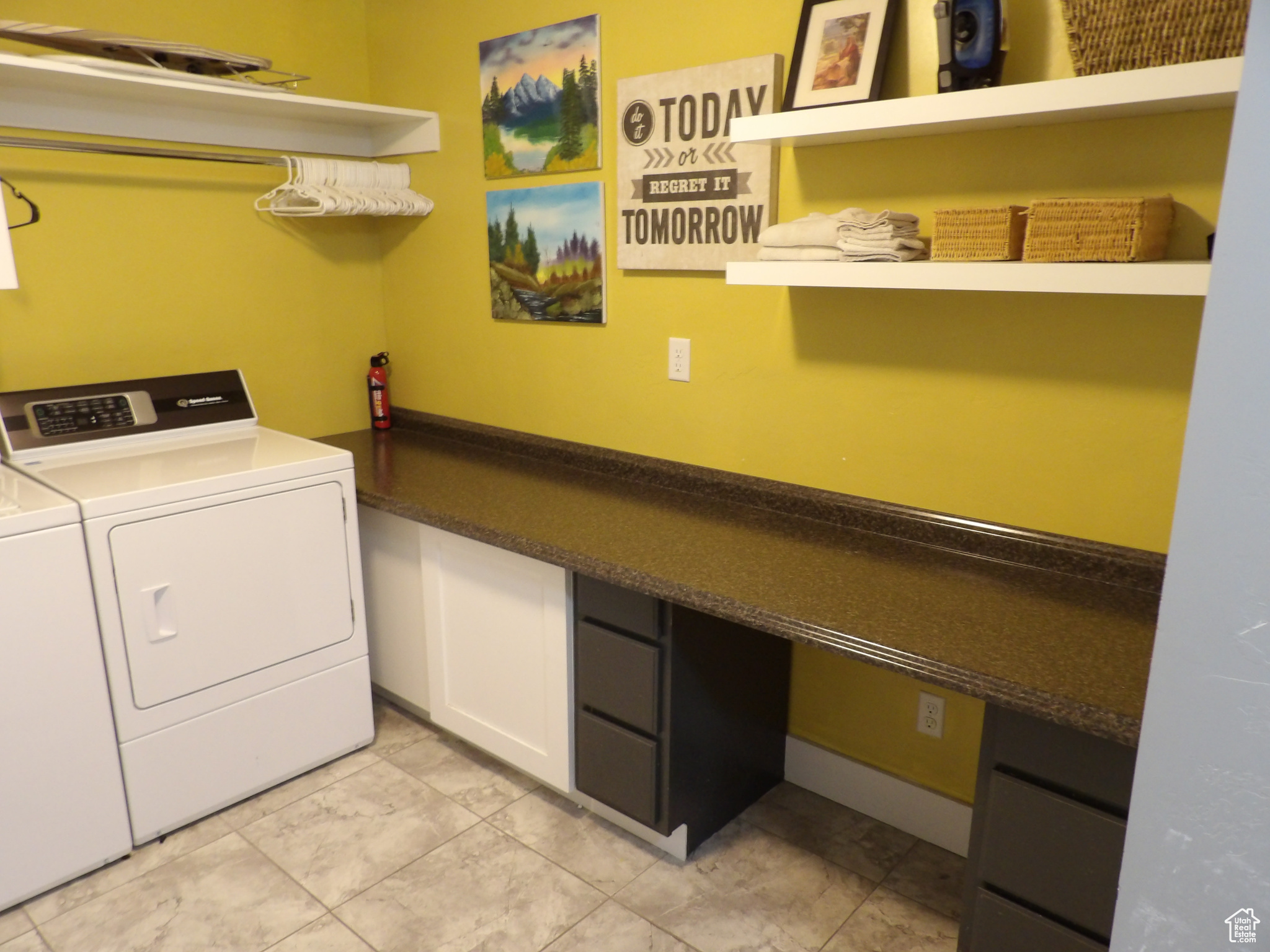 Laundry area featuring light tile flooring and washer and dryer