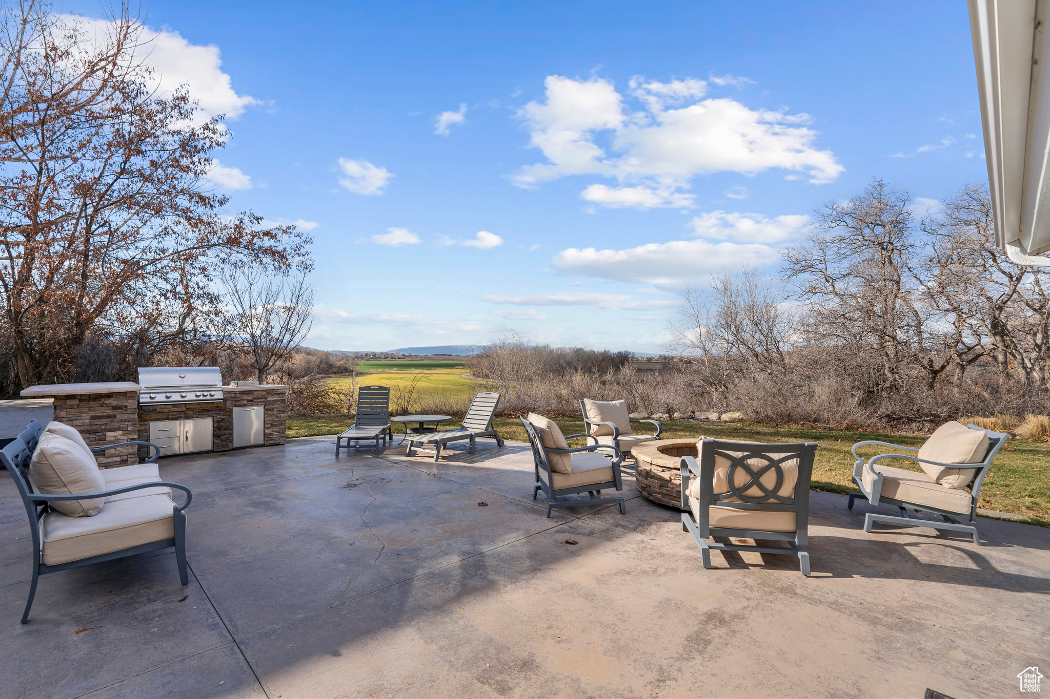 View of patio / terrace featuring grilling area and exterior kitchen with views of the riverbottoms looking to the northwest.