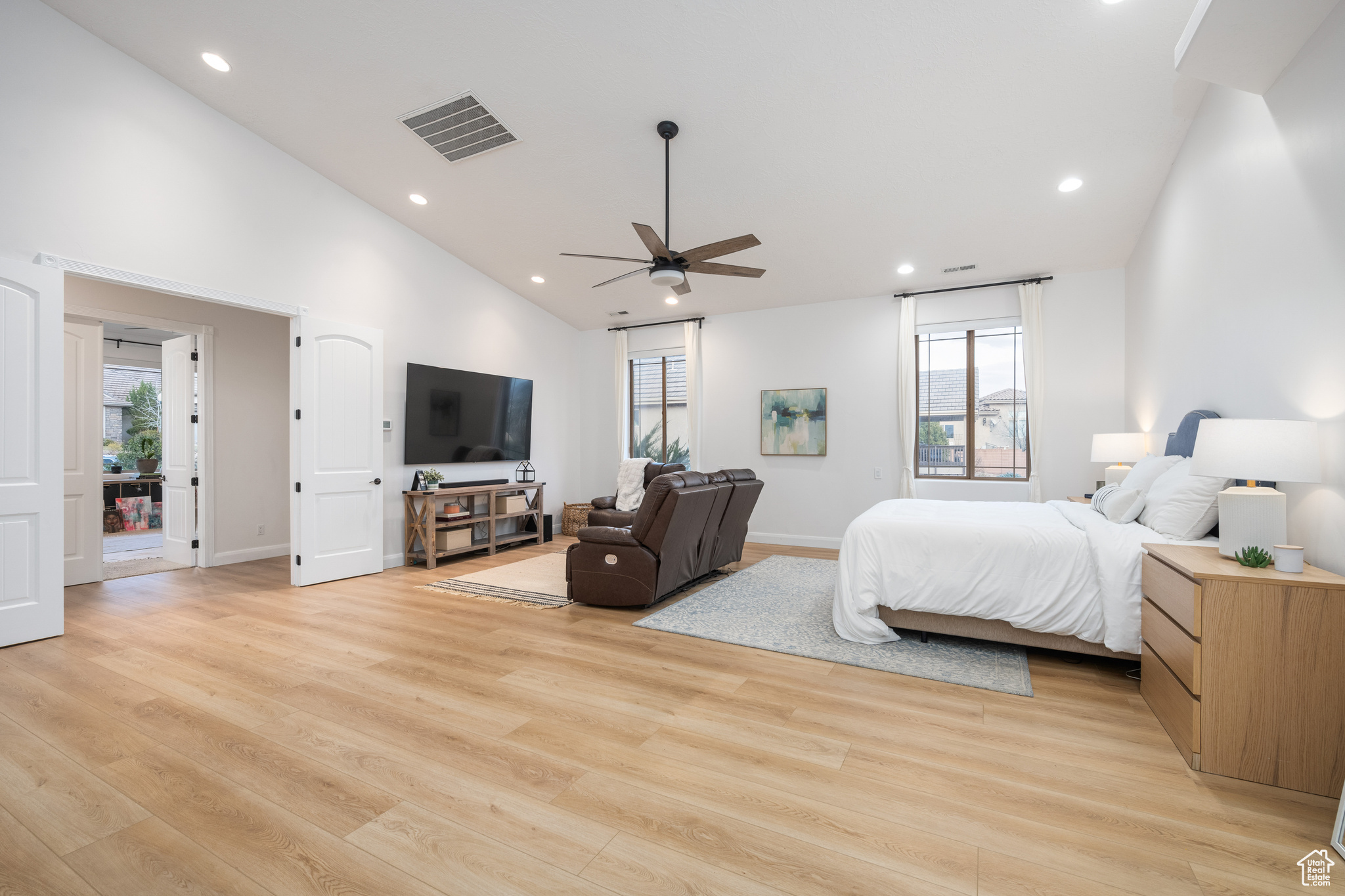 Bedroom featuring access to exterior, ceiling fan, multiple windows, and light hardwood / wood-style floors