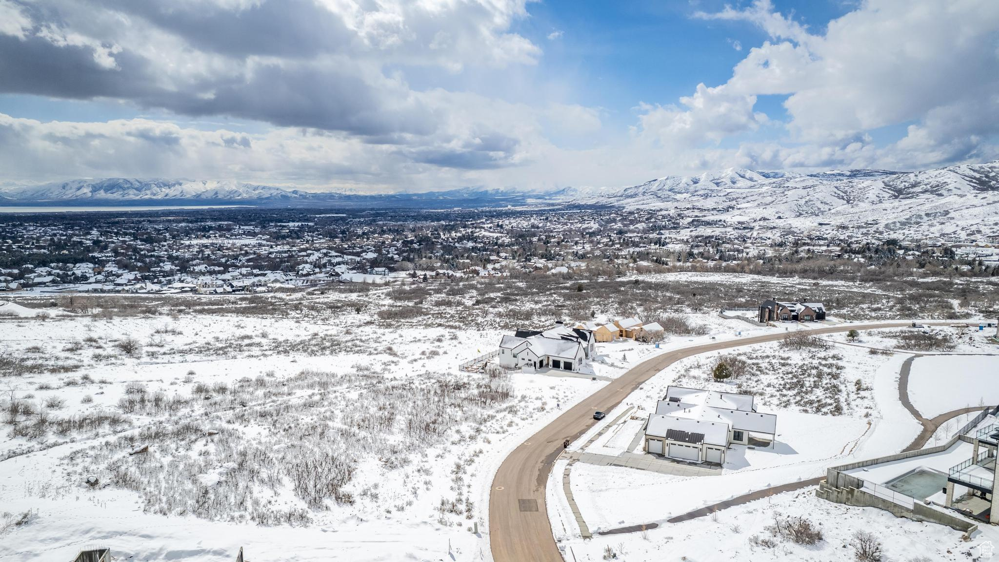 Snowy aerial view featuring a mountain view