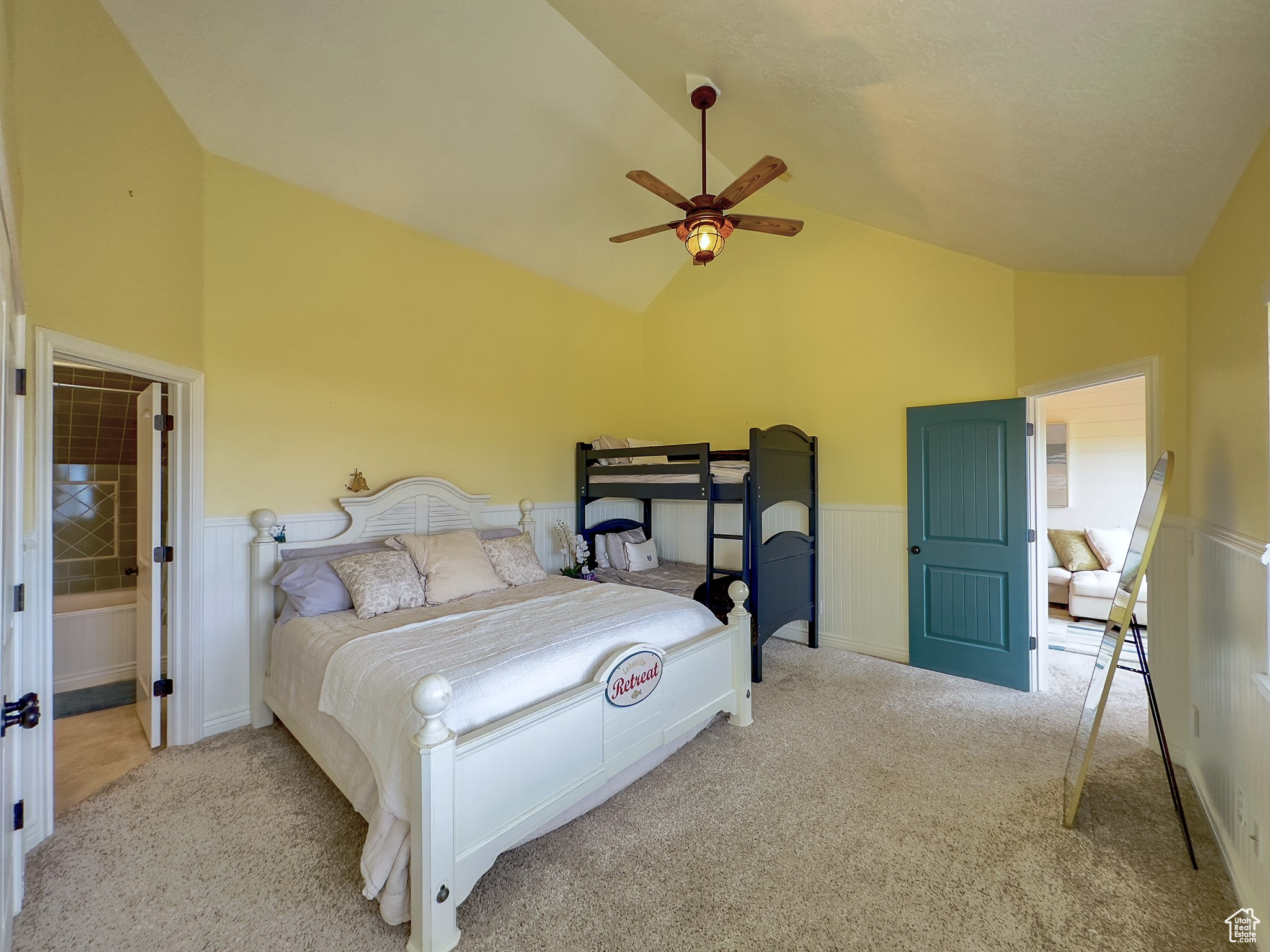 Carpeted bedroom featuring high vaulted ceiling and ceiling fan