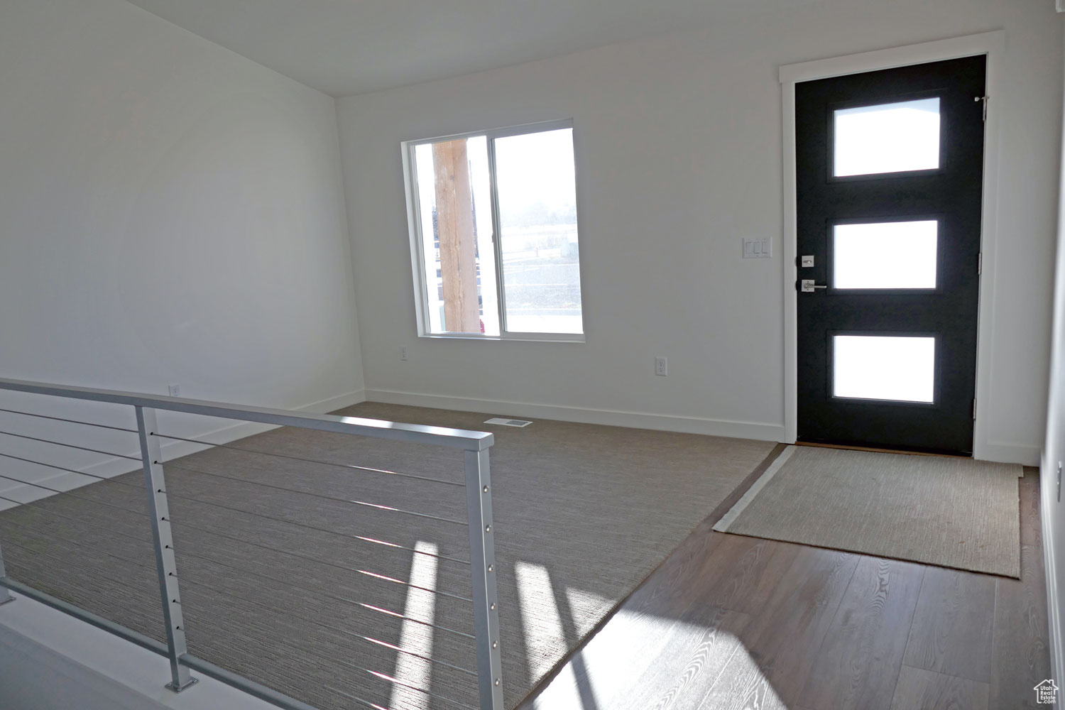 Entrance foyer with formal living room & light hardwood / wood-style flooring