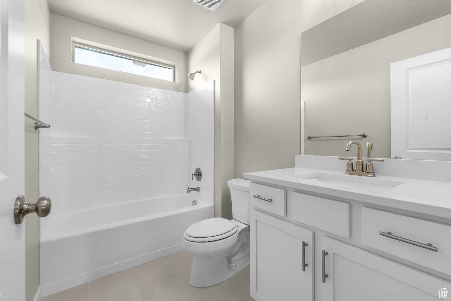 Full bathroom with tile floors, shower / bathing tub combination, toilet, and vanity