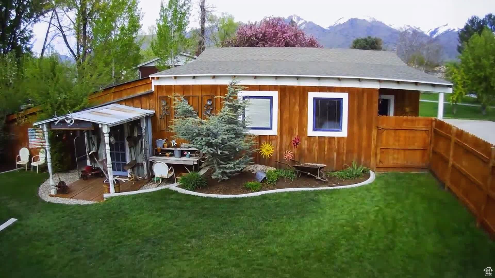 Rear view of property featuring a mountain view and a yard