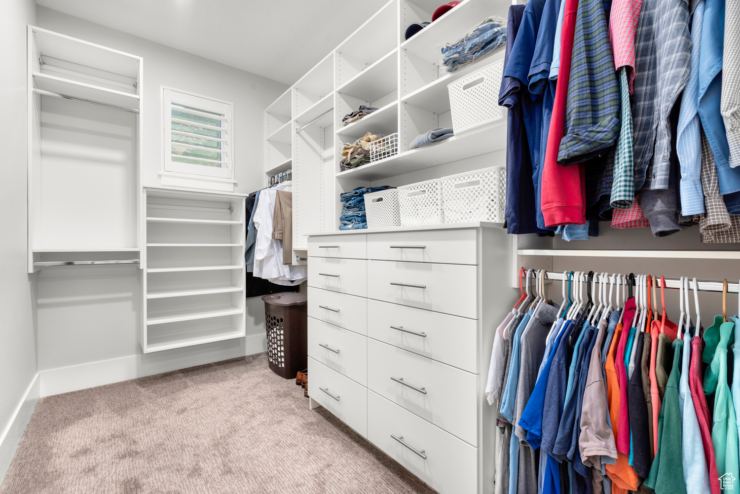 Spacious closet featuring light colored carpet