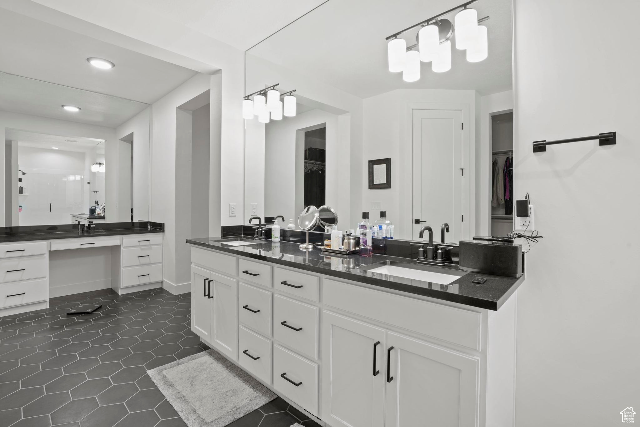 Bathroom featuring tile flooring and double sink vanity