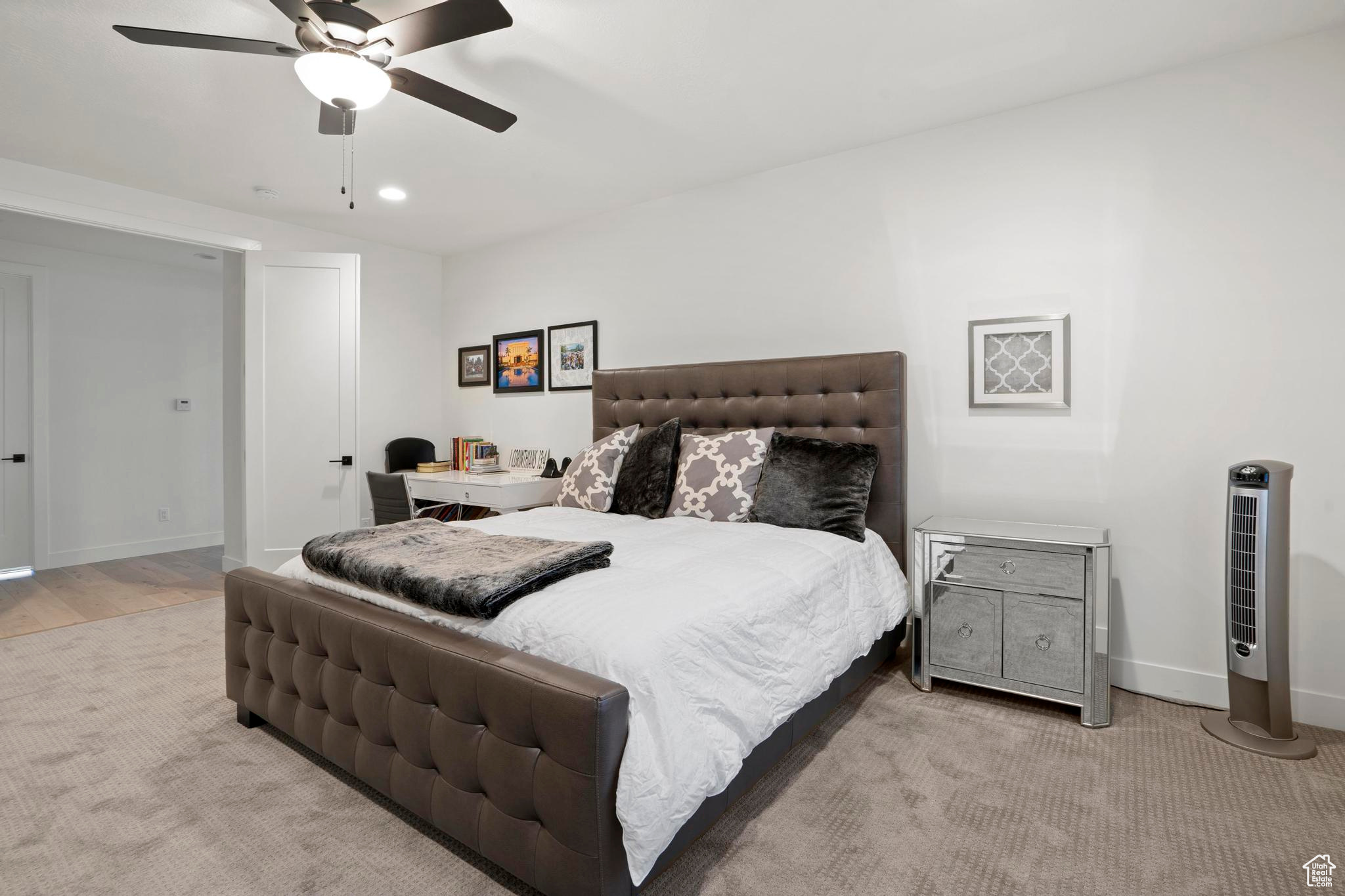 Bedroom featuring light colored carpet and ceiling fan