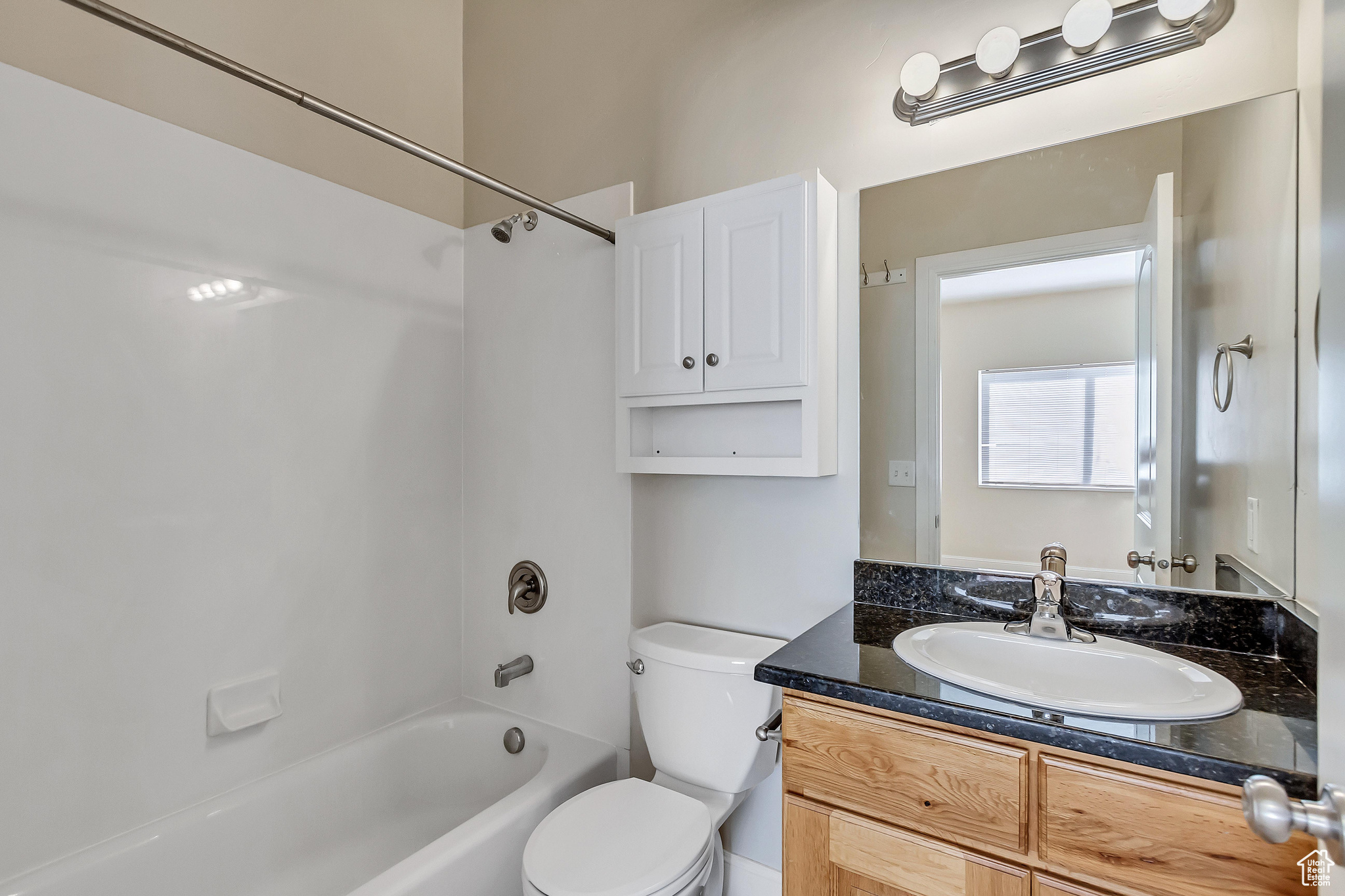 Full bathroom featuring vanity, toilet, and shower / washtub combination