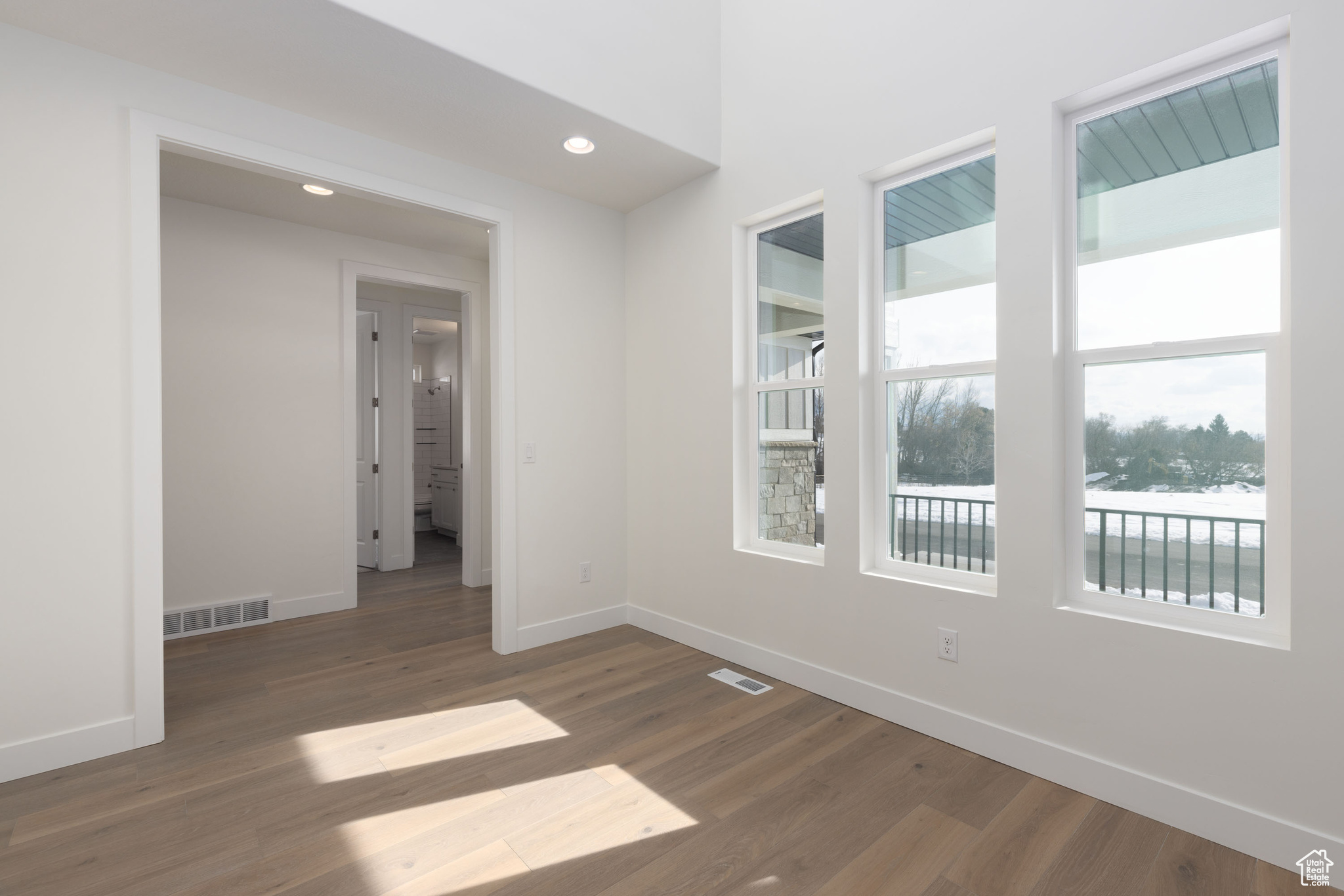 Empty room with dark hardwood / wood-style floors