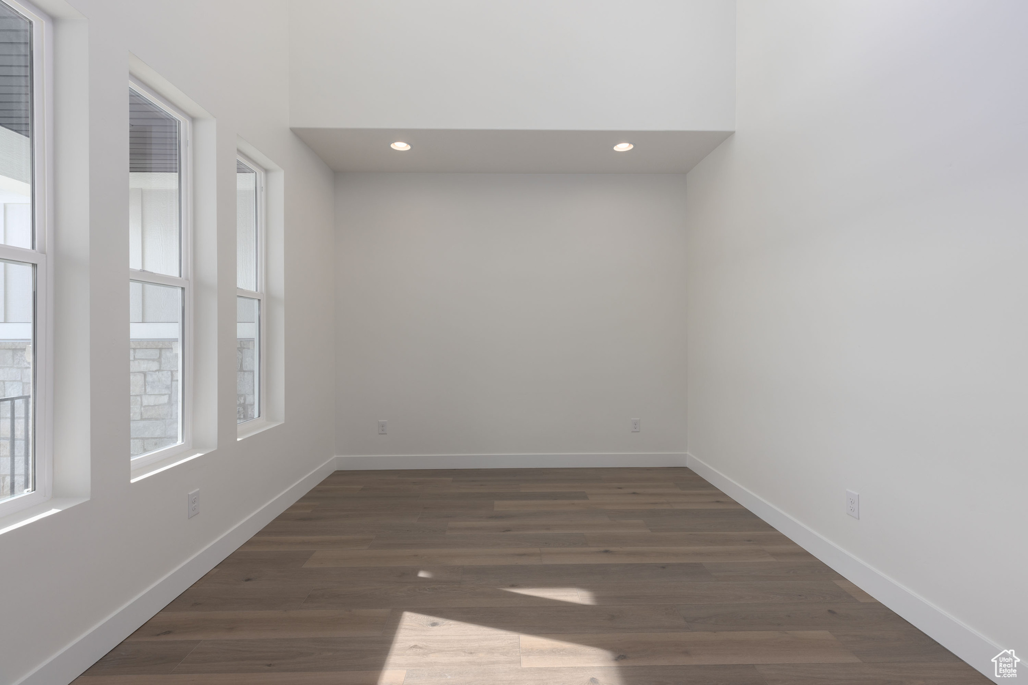 Unfurnished room featuring dark hardwood / wood-style flooring